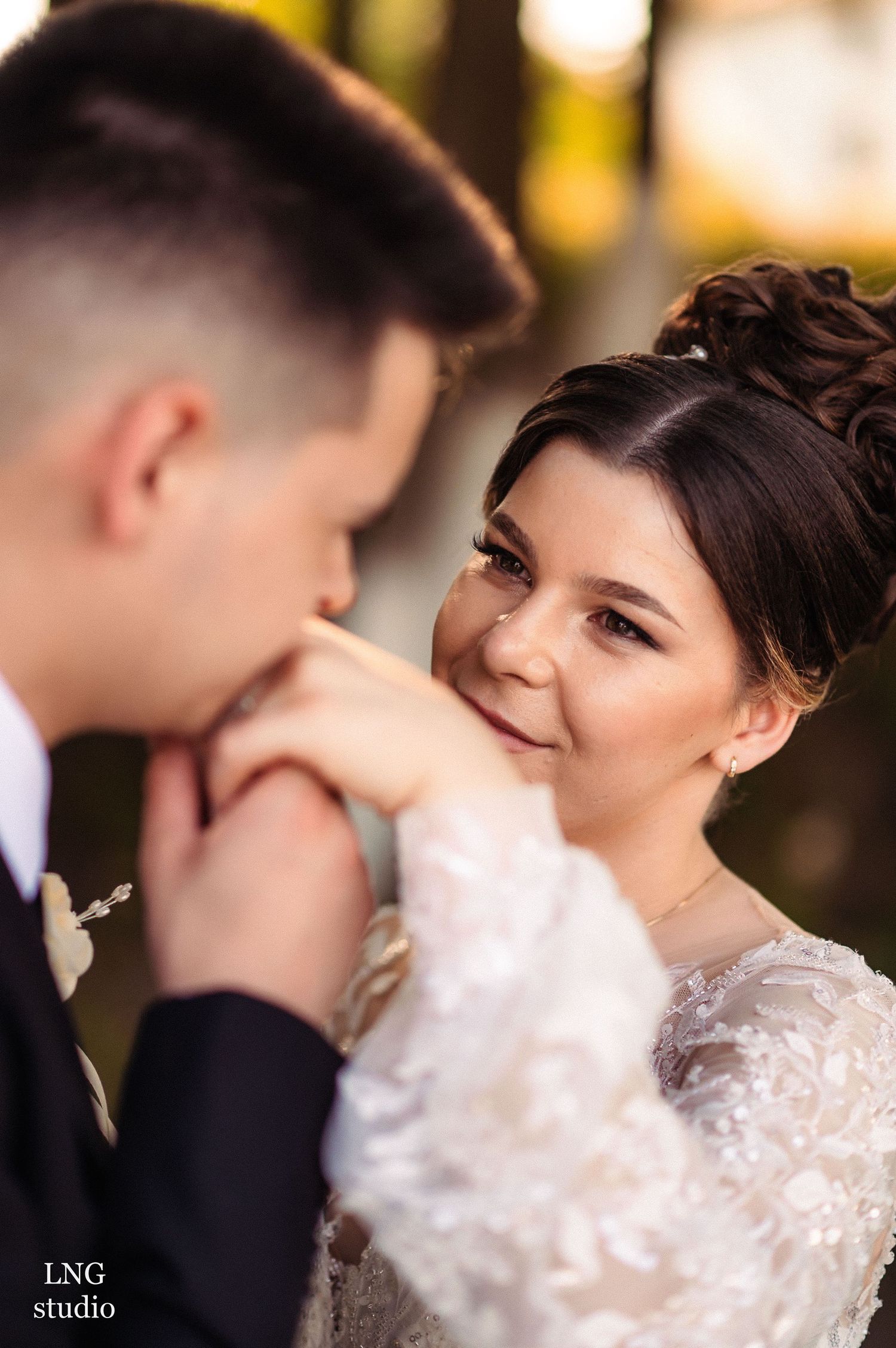 Close-up wedding portrait capturing romantic exchange between couple.