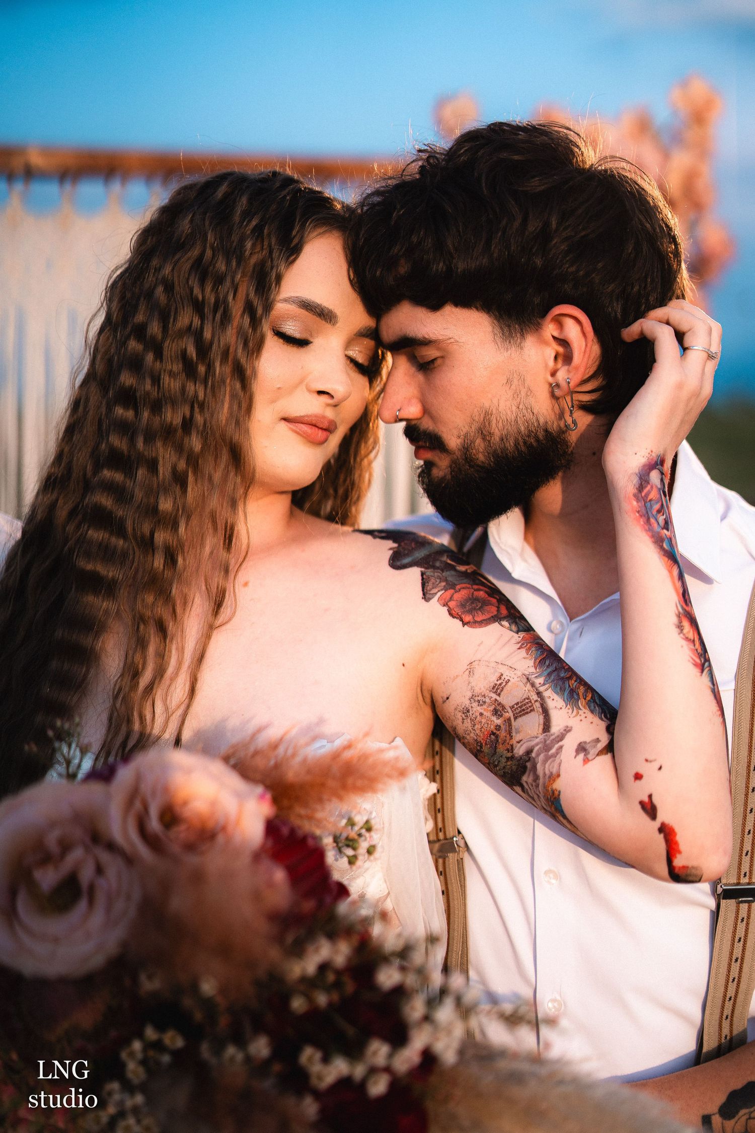 A romantic couple shares intimate moments in a series of close-up shots against a soft blue background at sunset.