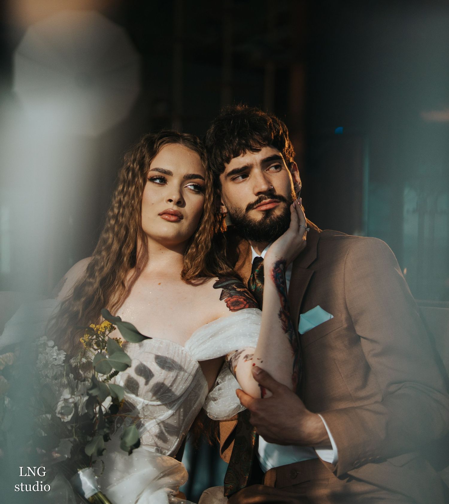 Romantic couple in formal attire creates artistic portrait series with dramatic lighting and smoke effects.