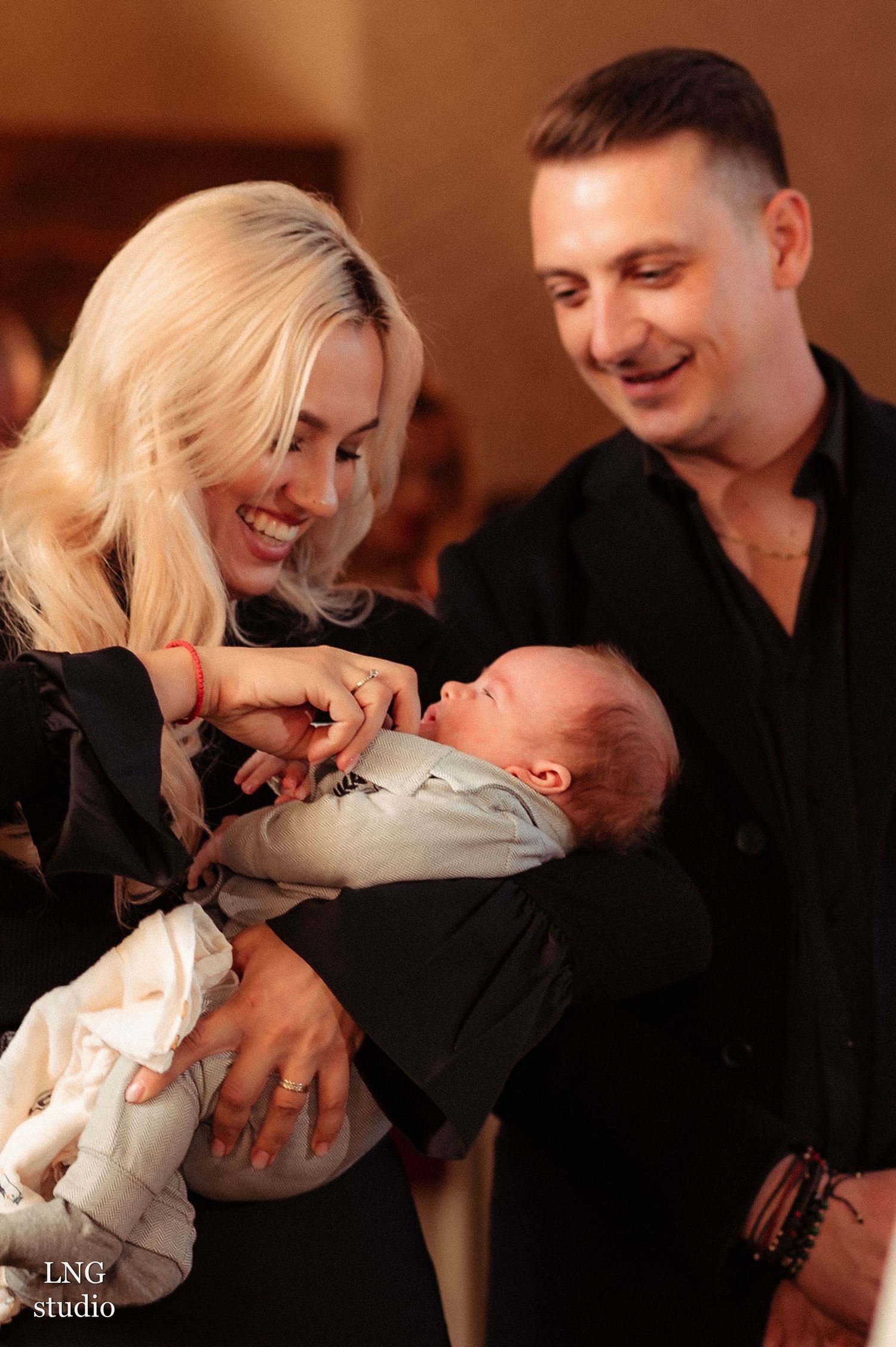 A heartwarming family moment with a newborn baby in a cozy indoor setting.