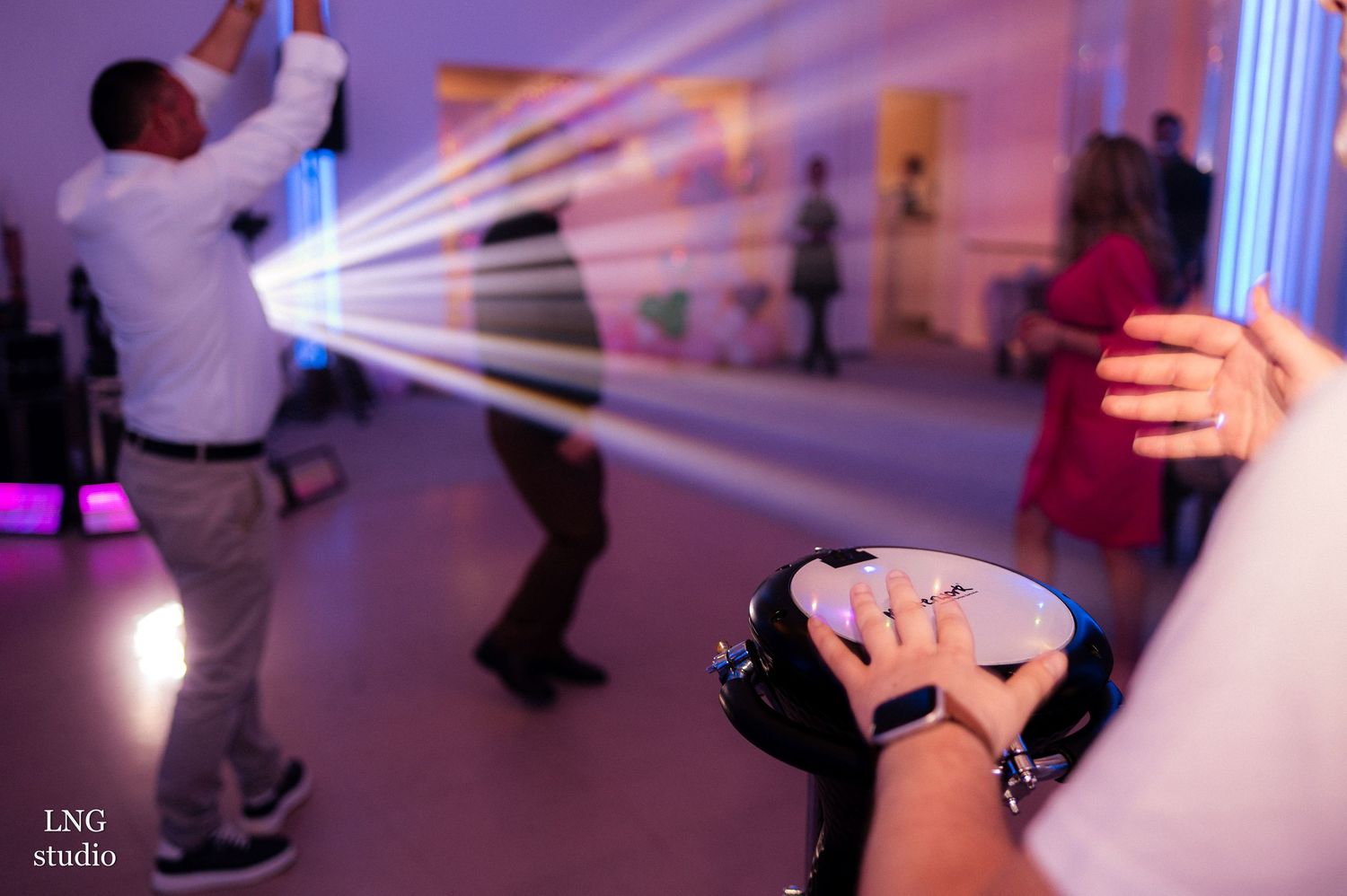 Dance floor with purple lighting and motion blur effects.