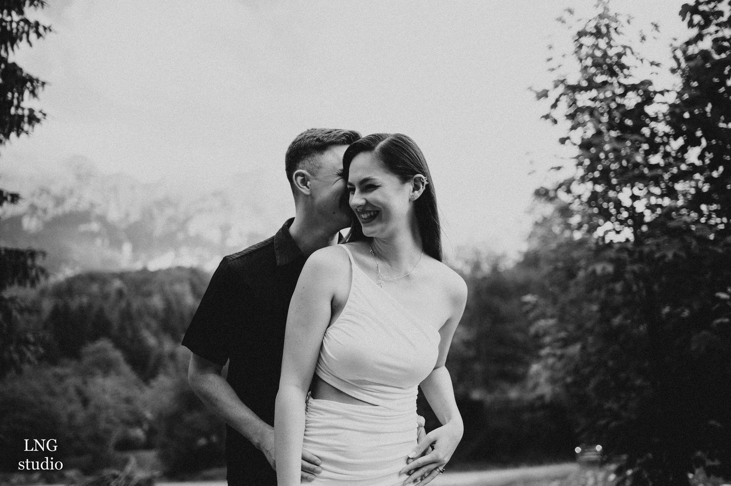 Black and white intimate couples photography in natural outdoor setting.