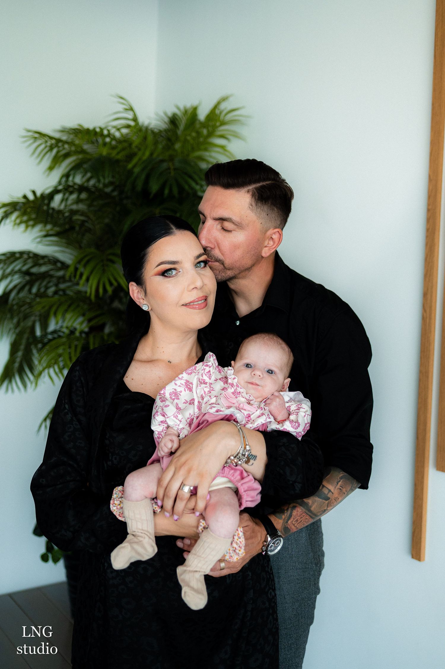 Intimate family portrait sequence showing tender moments with their baby in studio setting.