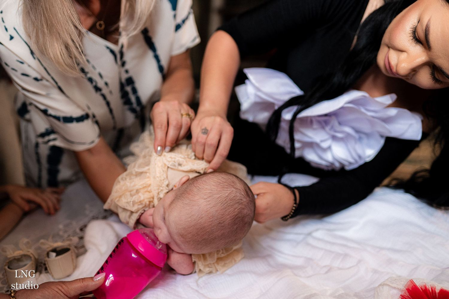 Close-up view of religious baptism ceremony with holy water being poured during traditional Orthodox Christian ritual.