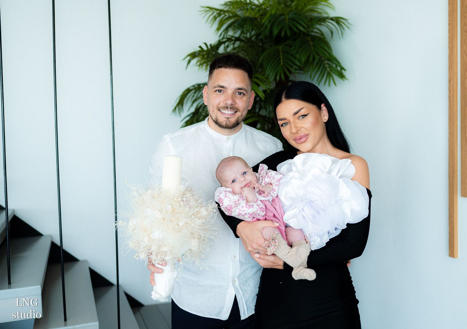 Candid family session captures natural interactions against contemporary studio setting.
