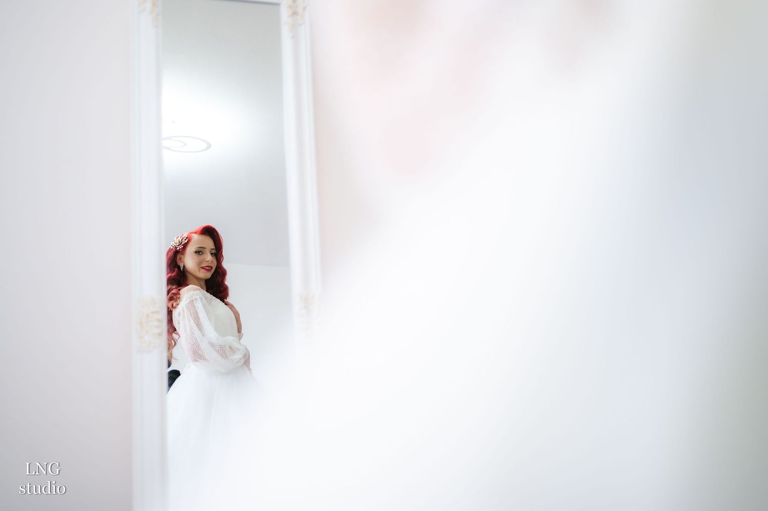 White bridal veil captured in ethereal natural light against neutral background.