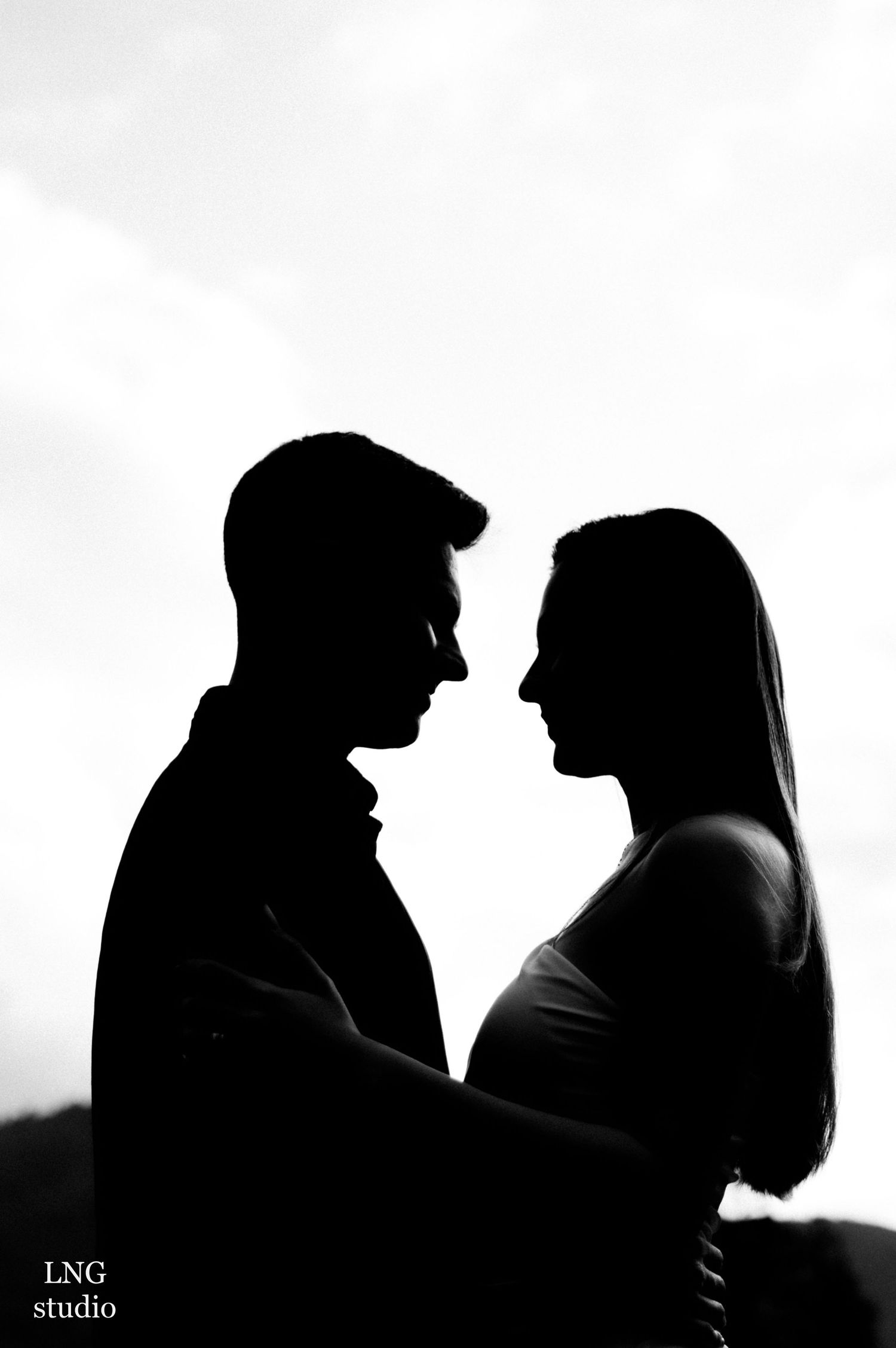 Romantic silhouette series showing couple against dark background with LNG studio watermark.