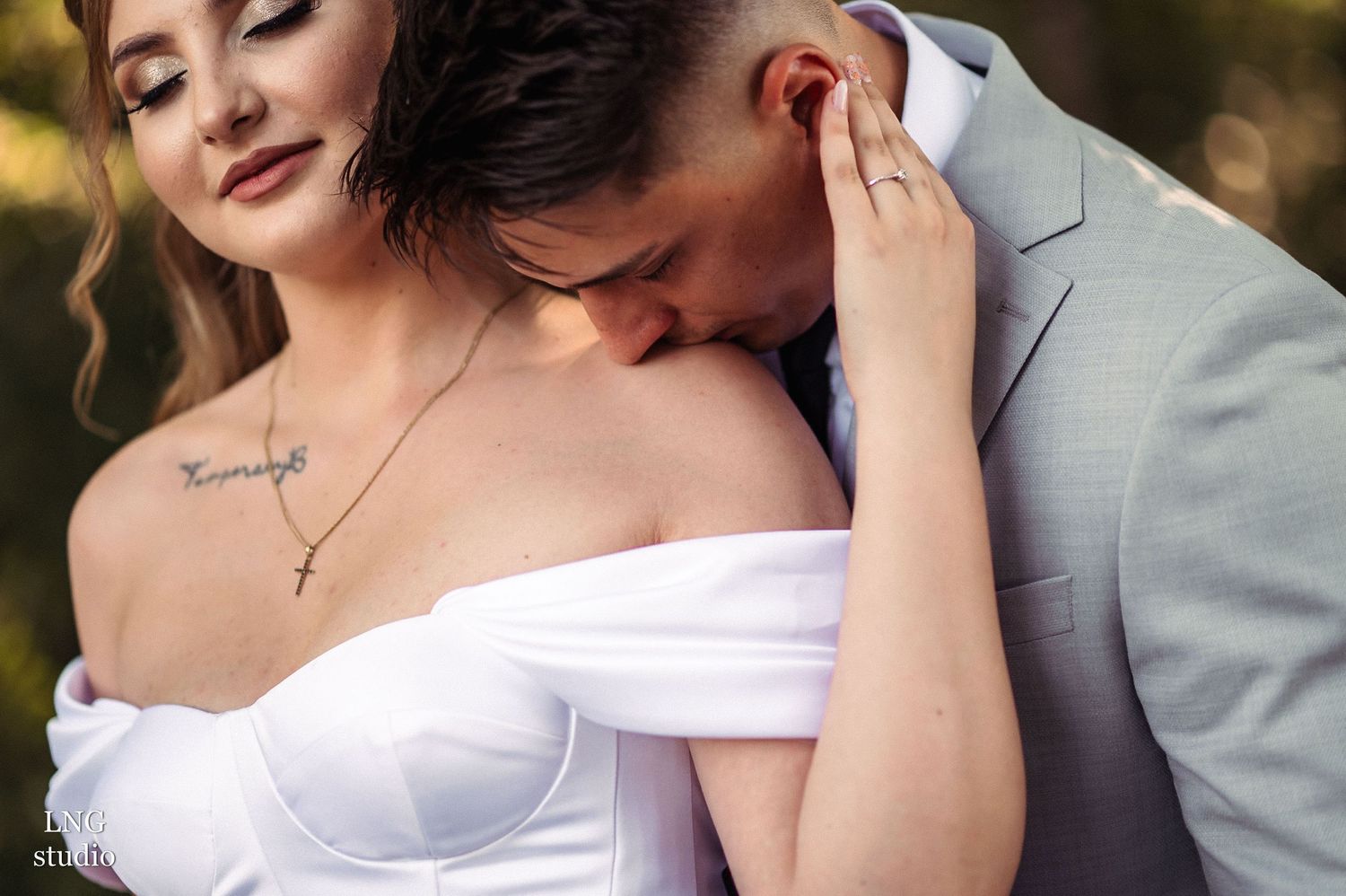 Intimate wedding portraits with elegant white dress details and romantic poses.
