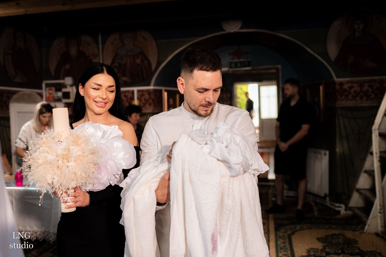 Spiritual baptism ceremony in progress inside an ornate church.