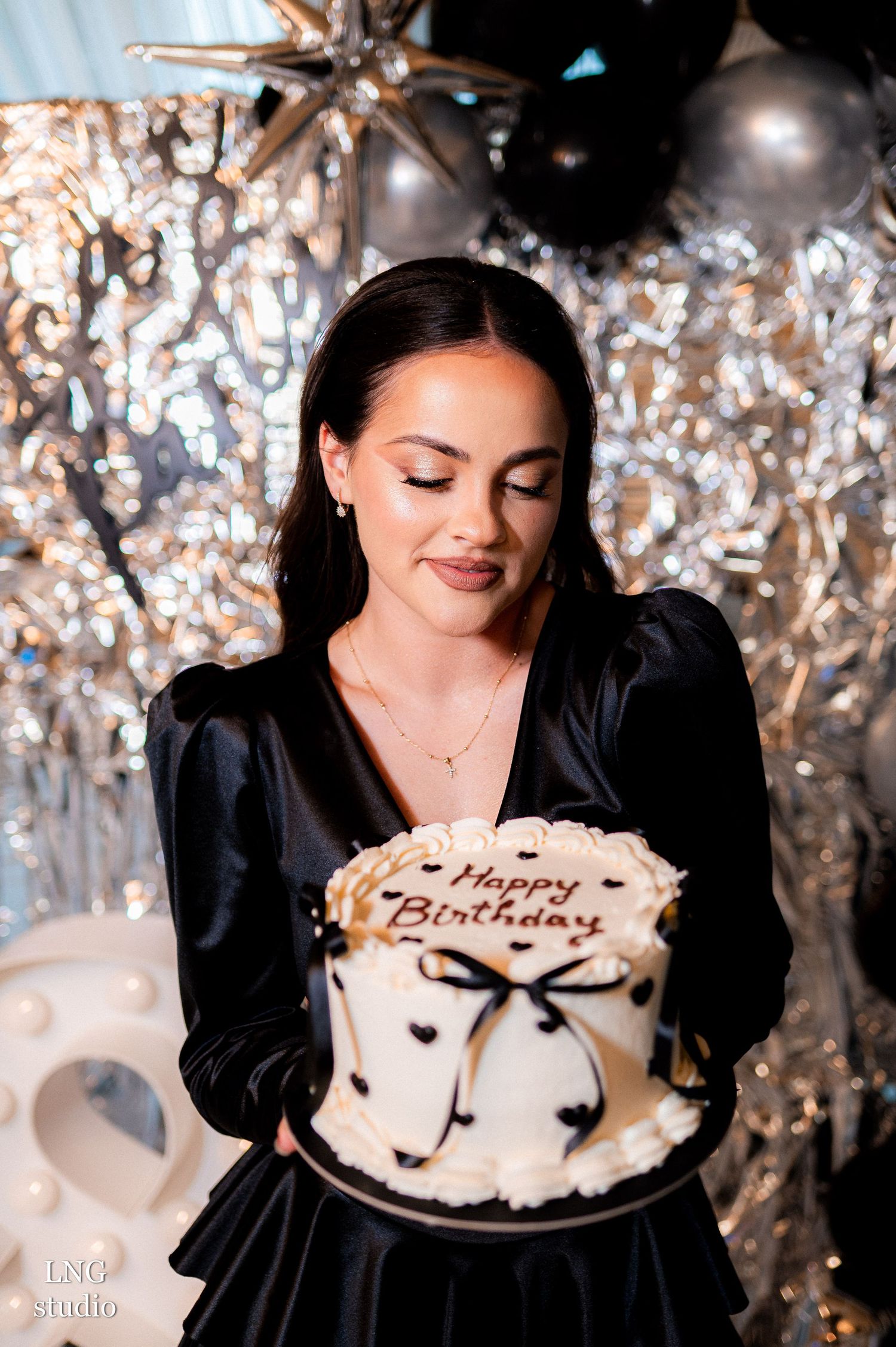 A collage of birthday celebration photos showing someone blowing out candles on a white frosted cake with sparkly decor.