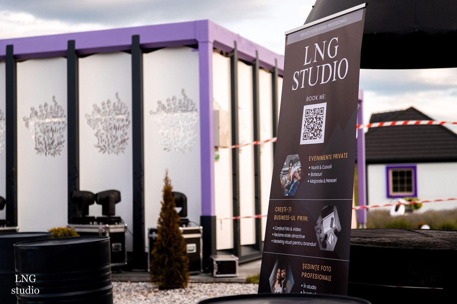 Exterior view of LNG Studio with purple accents and promotional signage on display.