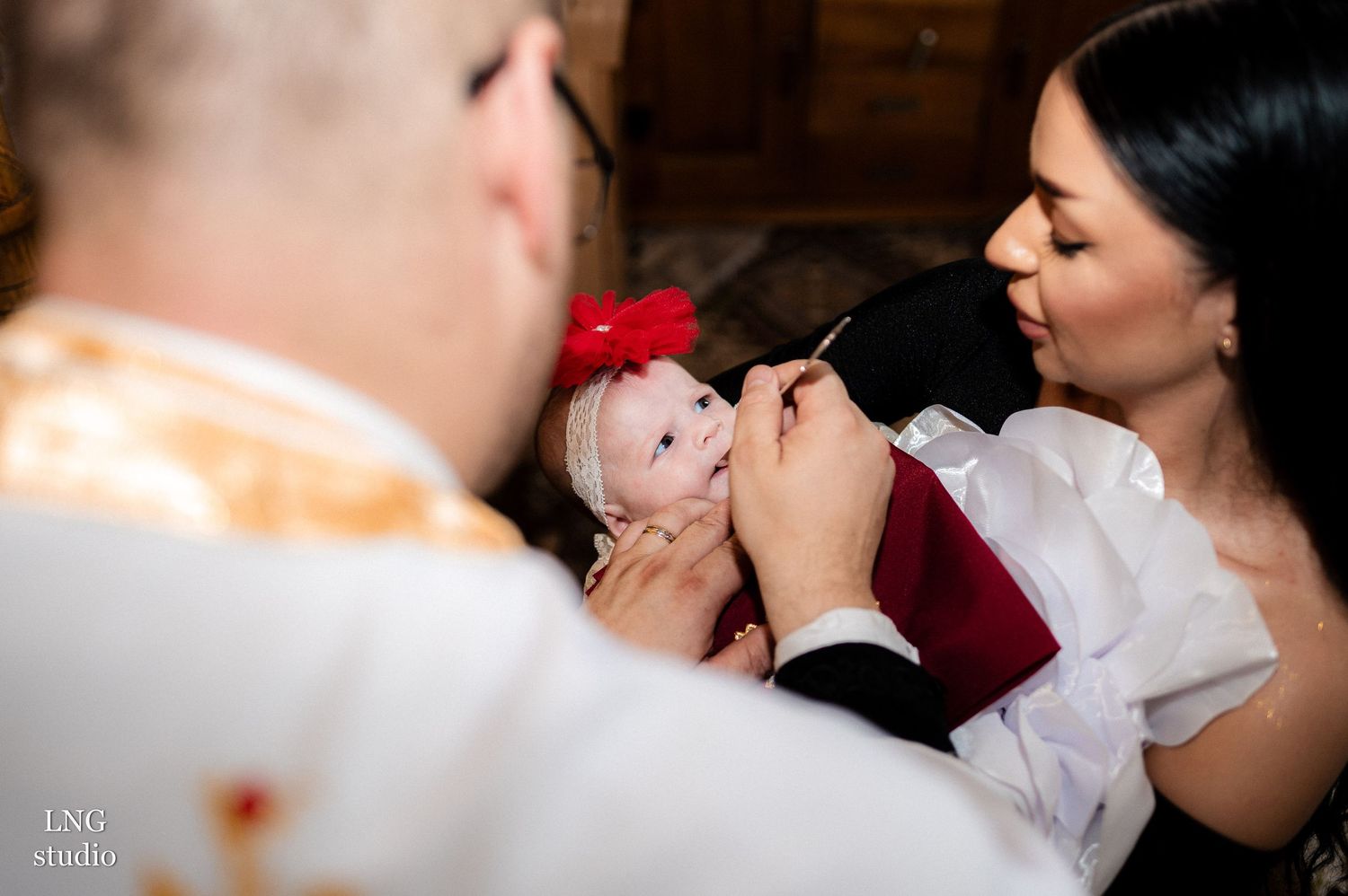 Intimate moment during an Orthodox Christian ceremony with traditional religious elements.