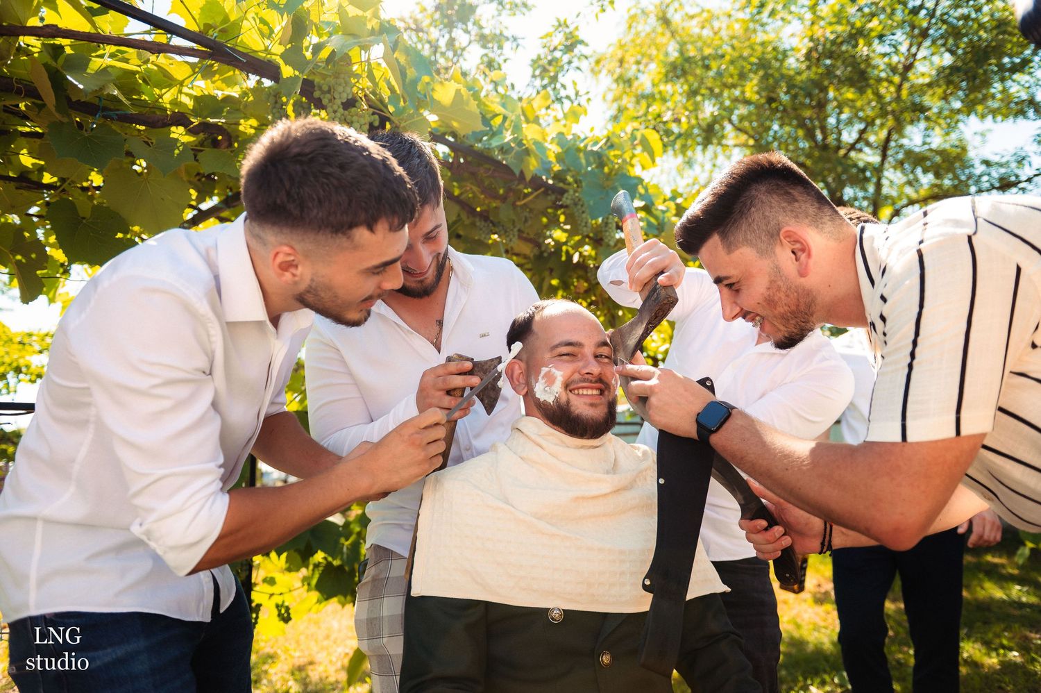 Playful pre-wedding moment captured in sunlit outdoor setting.