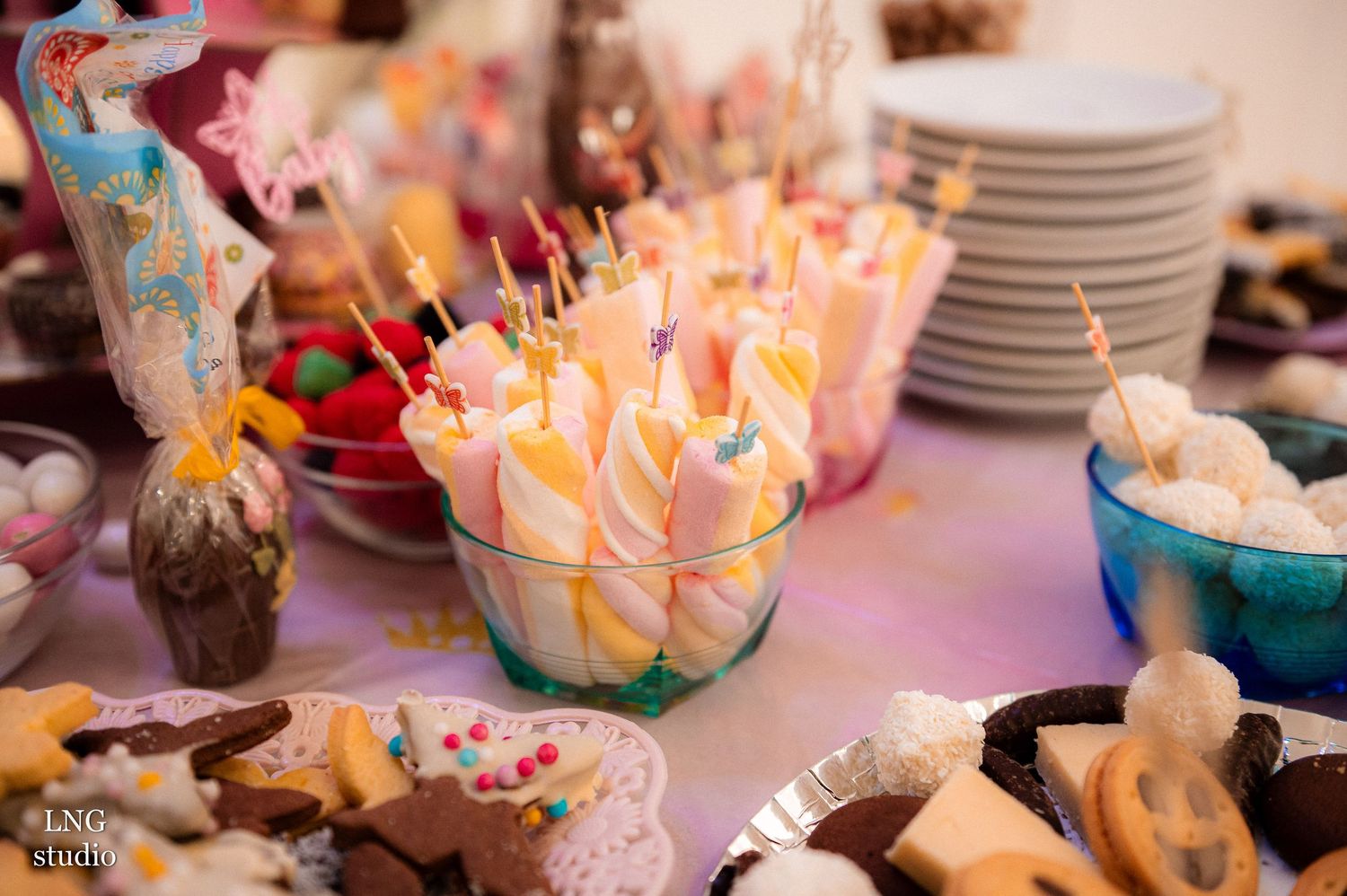 Dessert table setup with colorful treats and sweets at a celebration event.