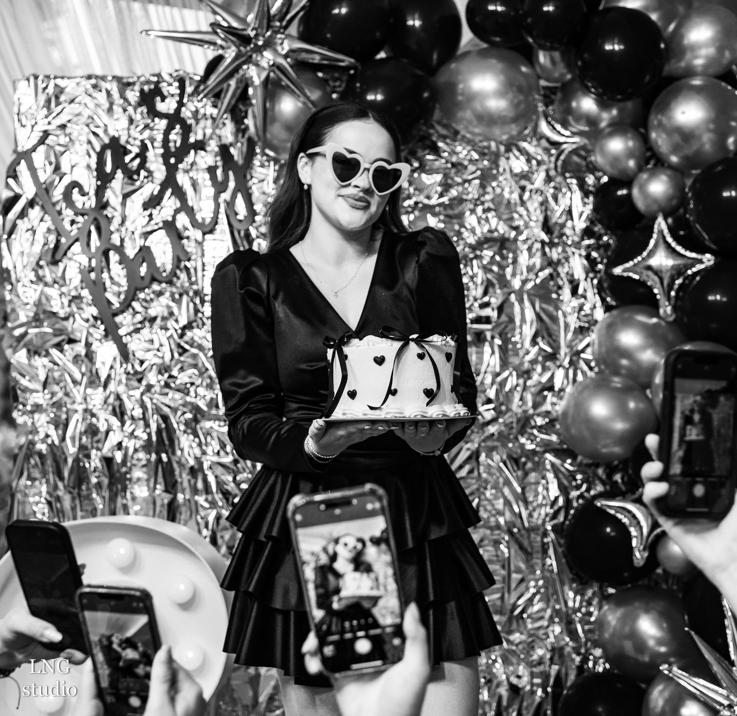 Black and white photo series showing people enjoying a disco party with mirrors and silver balls in a dimly lit venue.