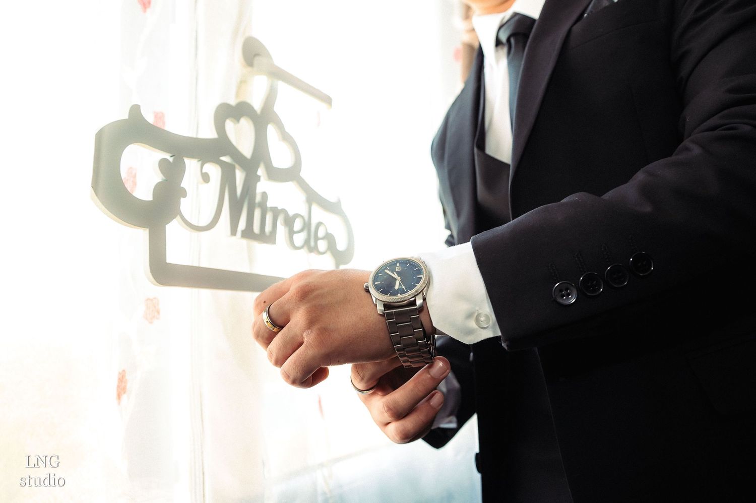 Close-up details of formal attire and accessories in dramatic lighting.