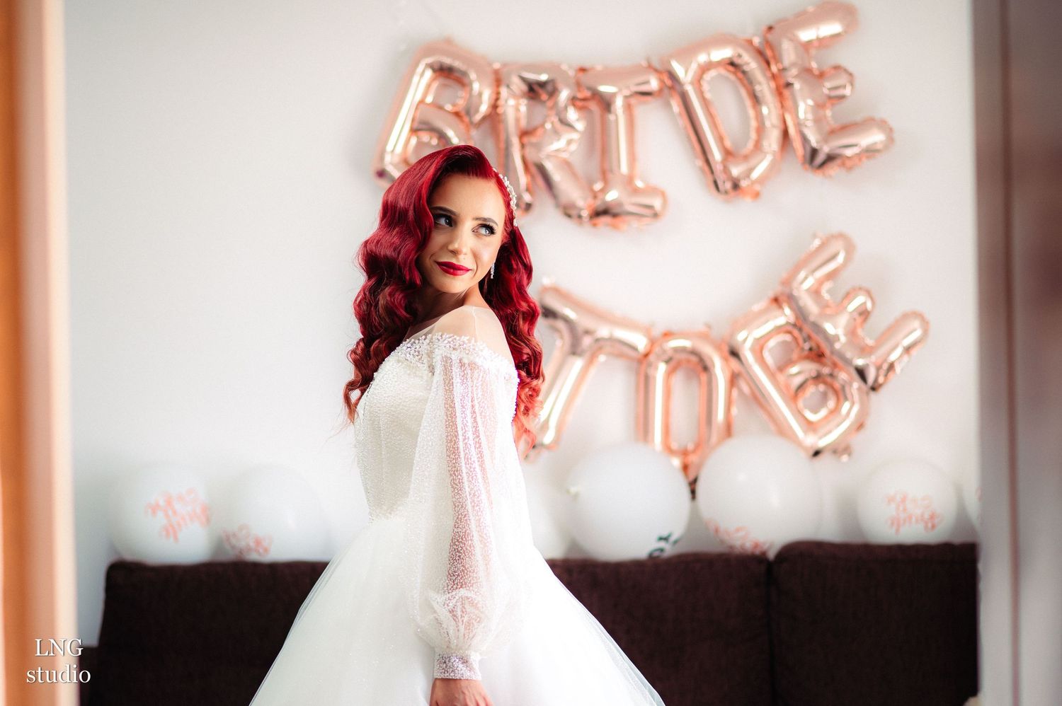 Elegant bridal preparations with rose gold balloon decor and pink accents.