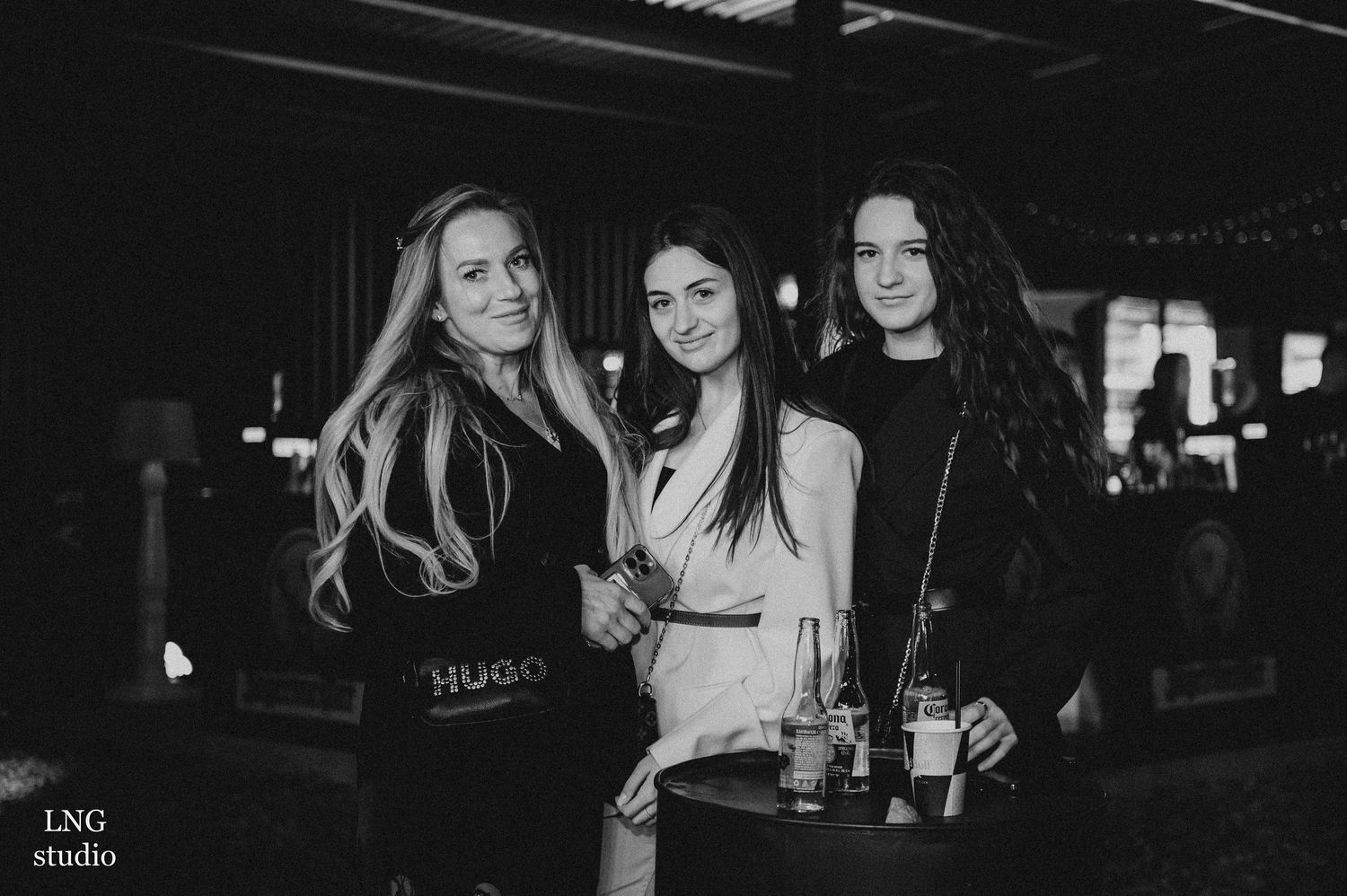 Dark nightclub or bar setting with atmospheric lighting and crowd.