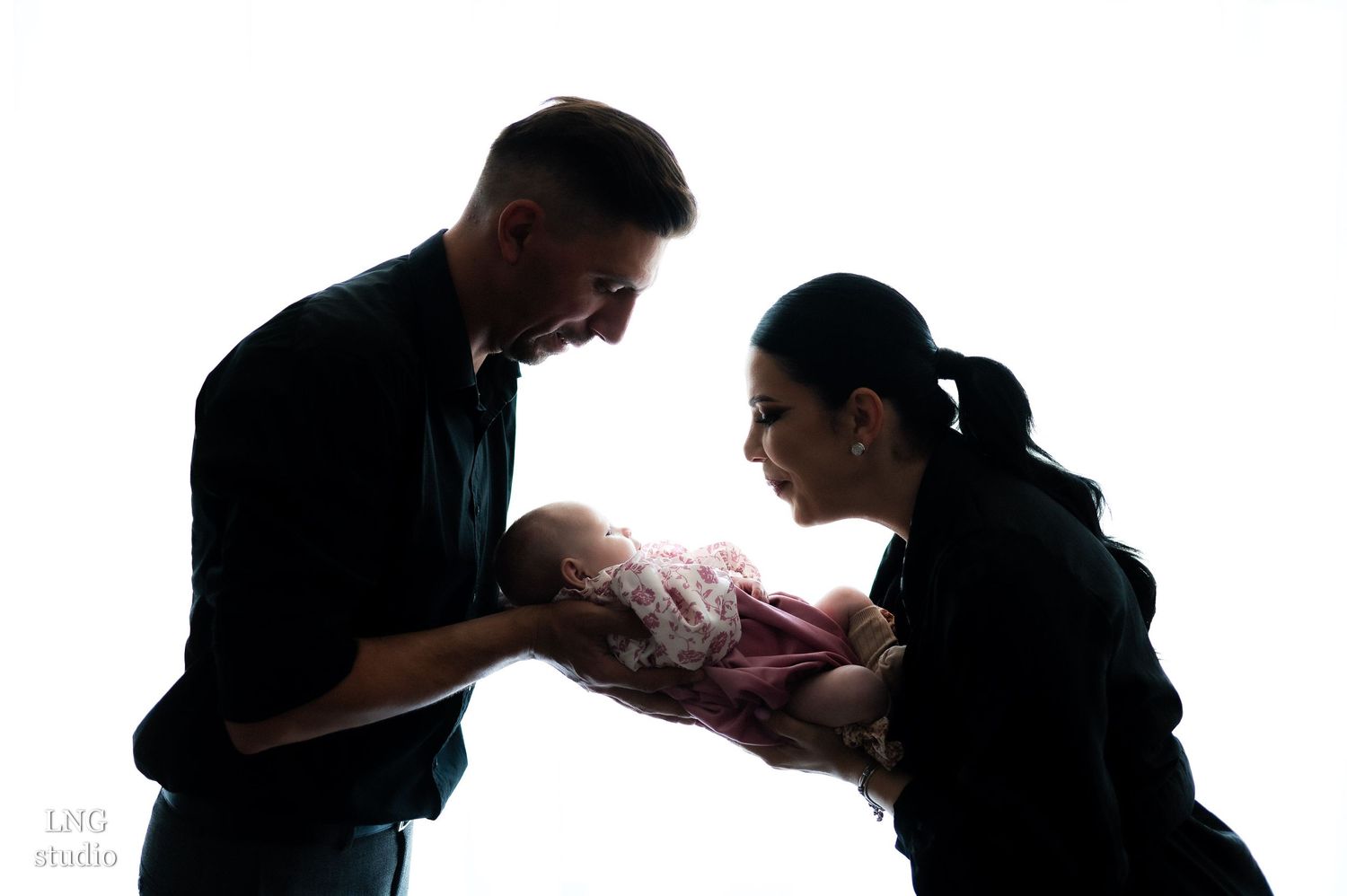 Dramatic silhouette photos capture tender family moments in sequence.