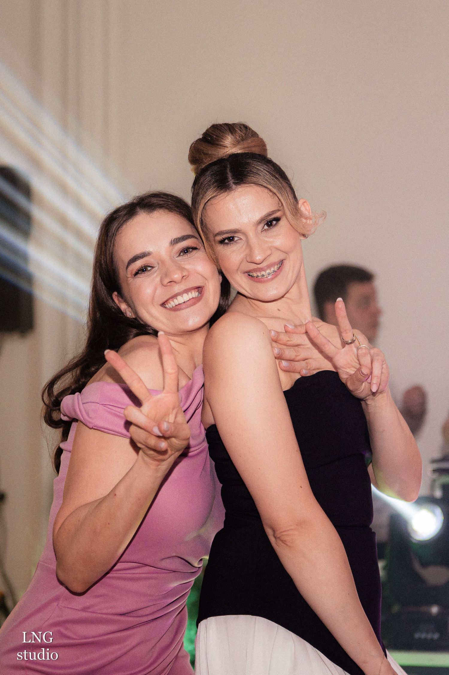 Friends posing together at a formal event in elegant attire.