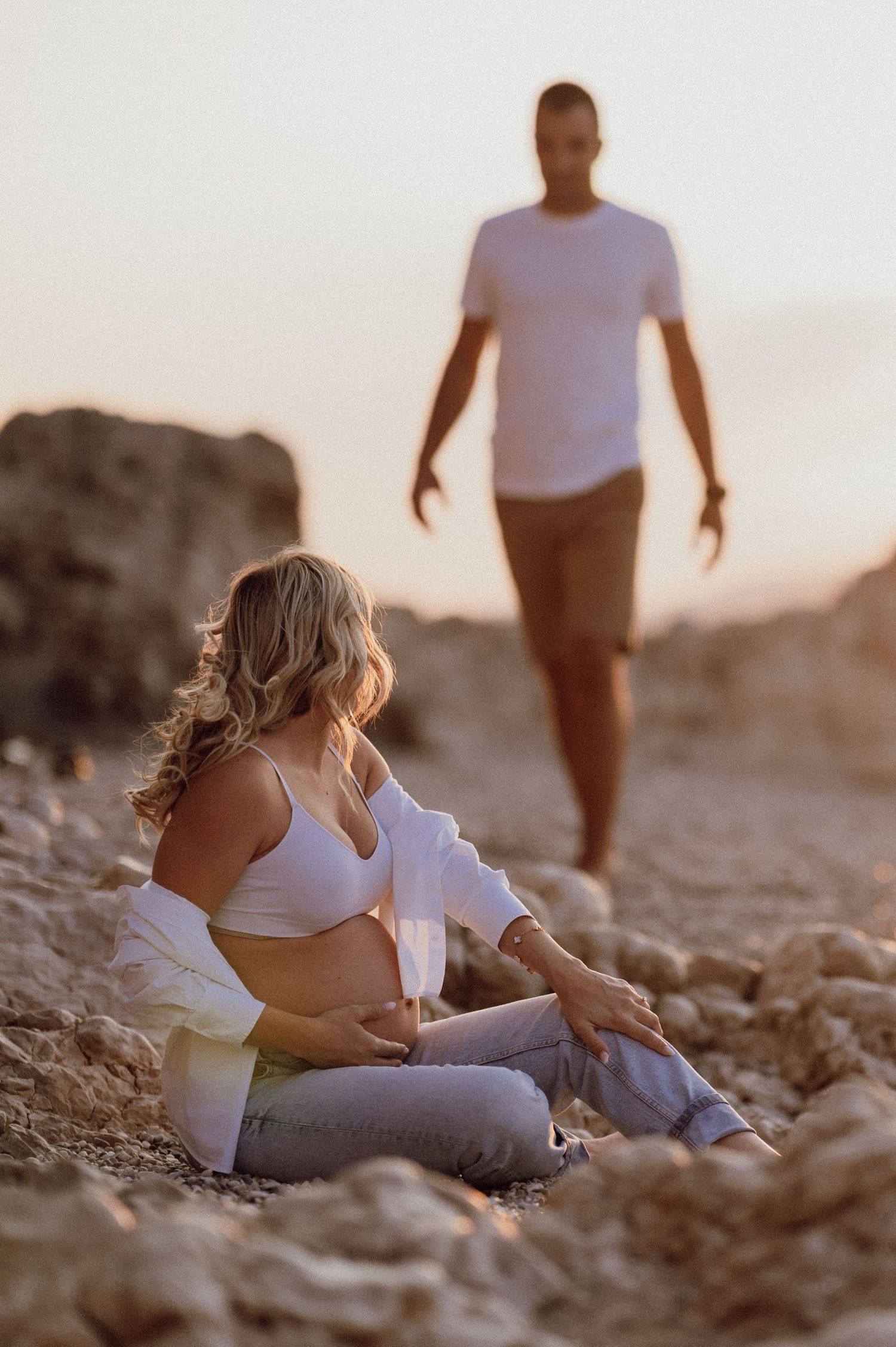 Maternity photoshoot at dawn with couple embracing on the sandy shore, Istria