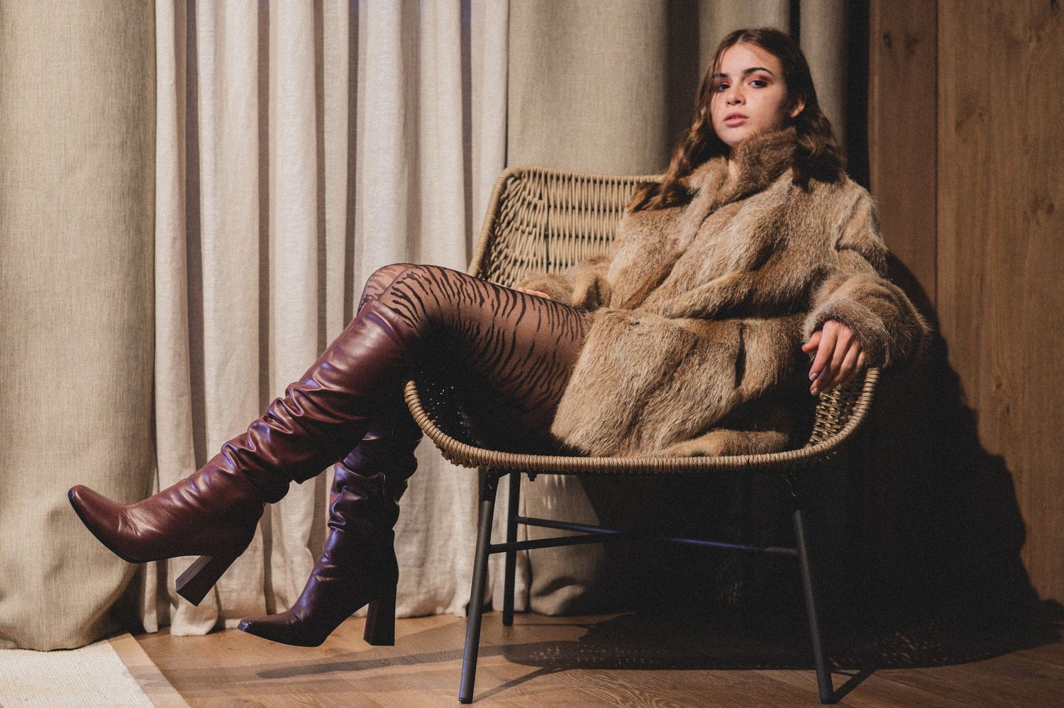 Fashion model wearing a stylish fur coat and boots – Croatia