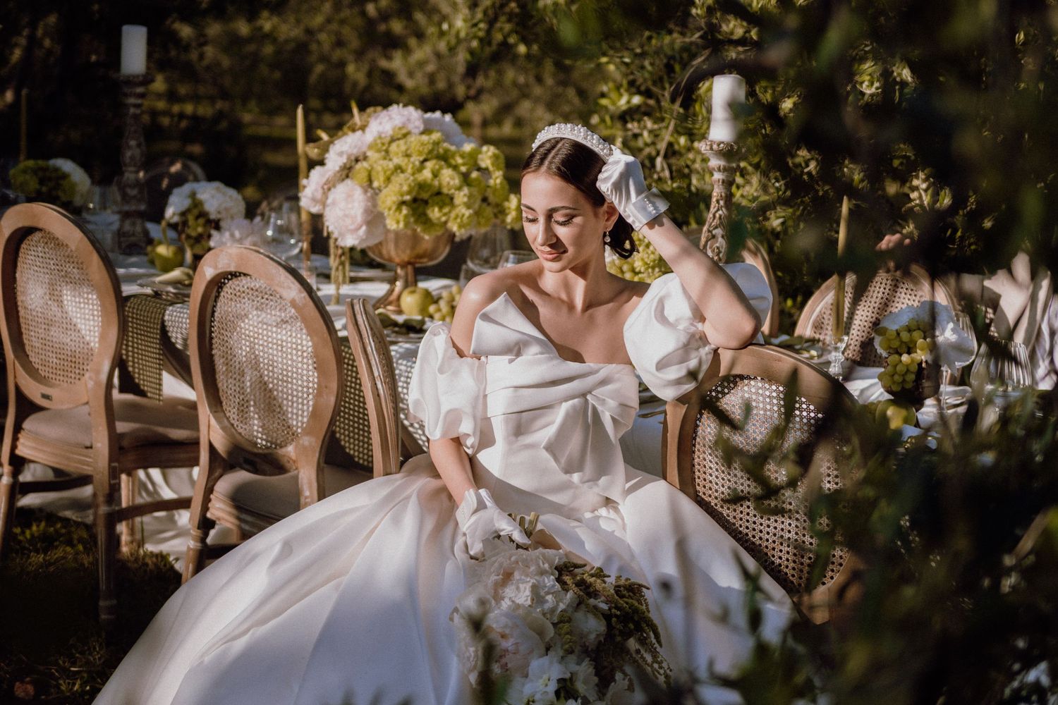 Bride posing gracefully in a sunlit olive grove in Istria