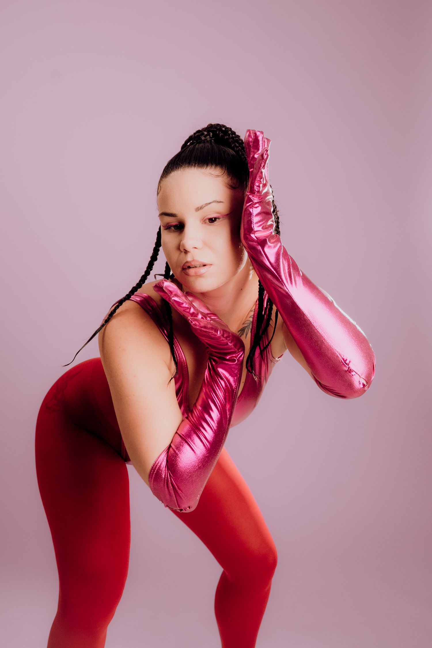 Creative editorial shot of a model in dramatic gloves with hands raised – Croatia