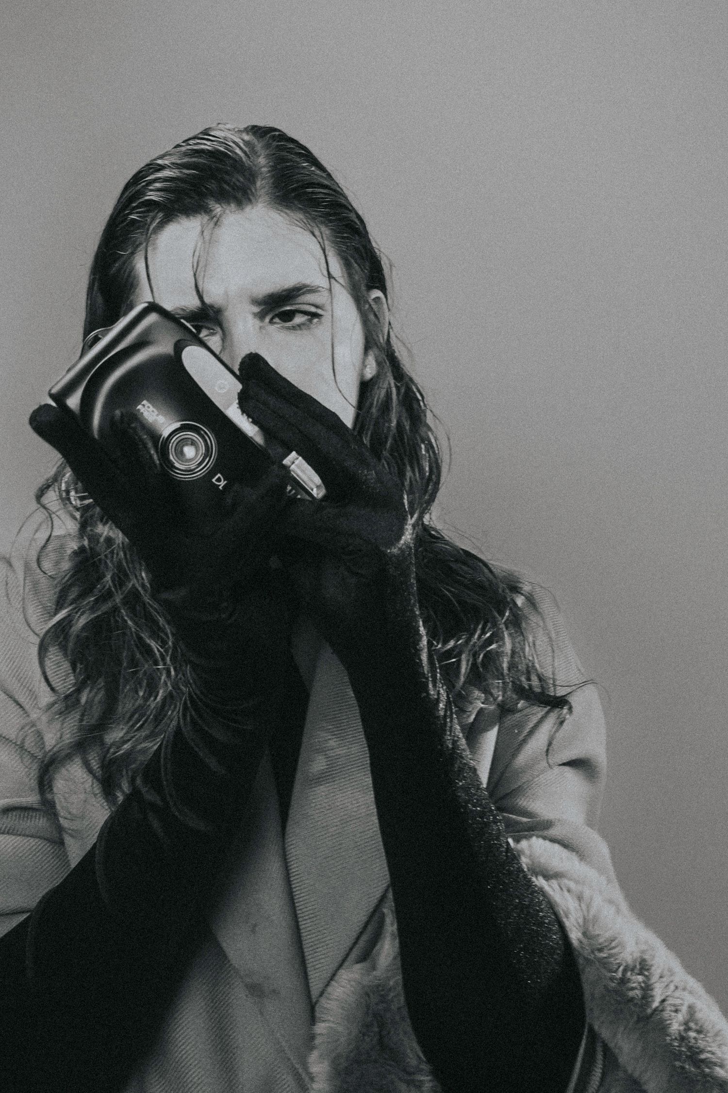 Artistic fashion portrait of a woman holding a retro camera in a creative pose – Croatia
