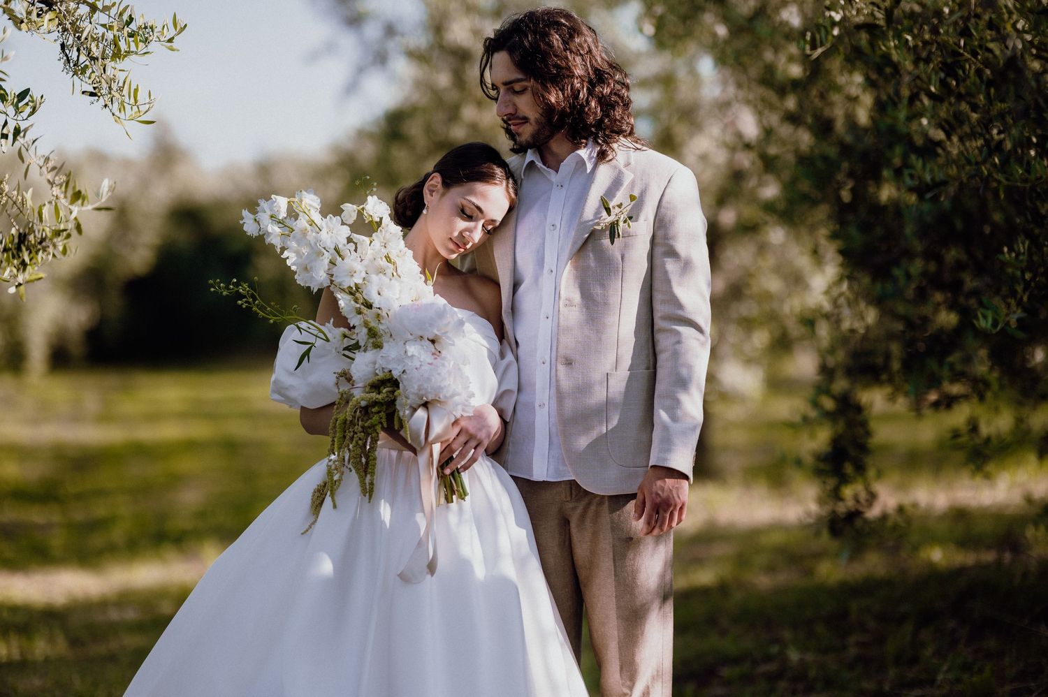 Loving couple sharing a romantic moment in a sunlit olive grove in Istria, Croatia