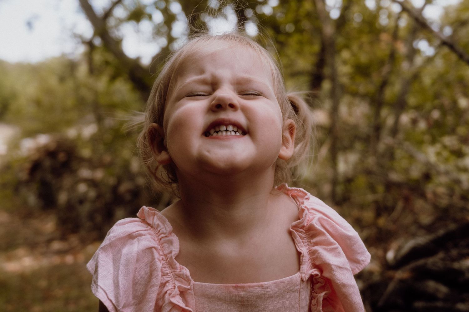 Little girl smiling and playing outdoors in a natural setting, Croatia
