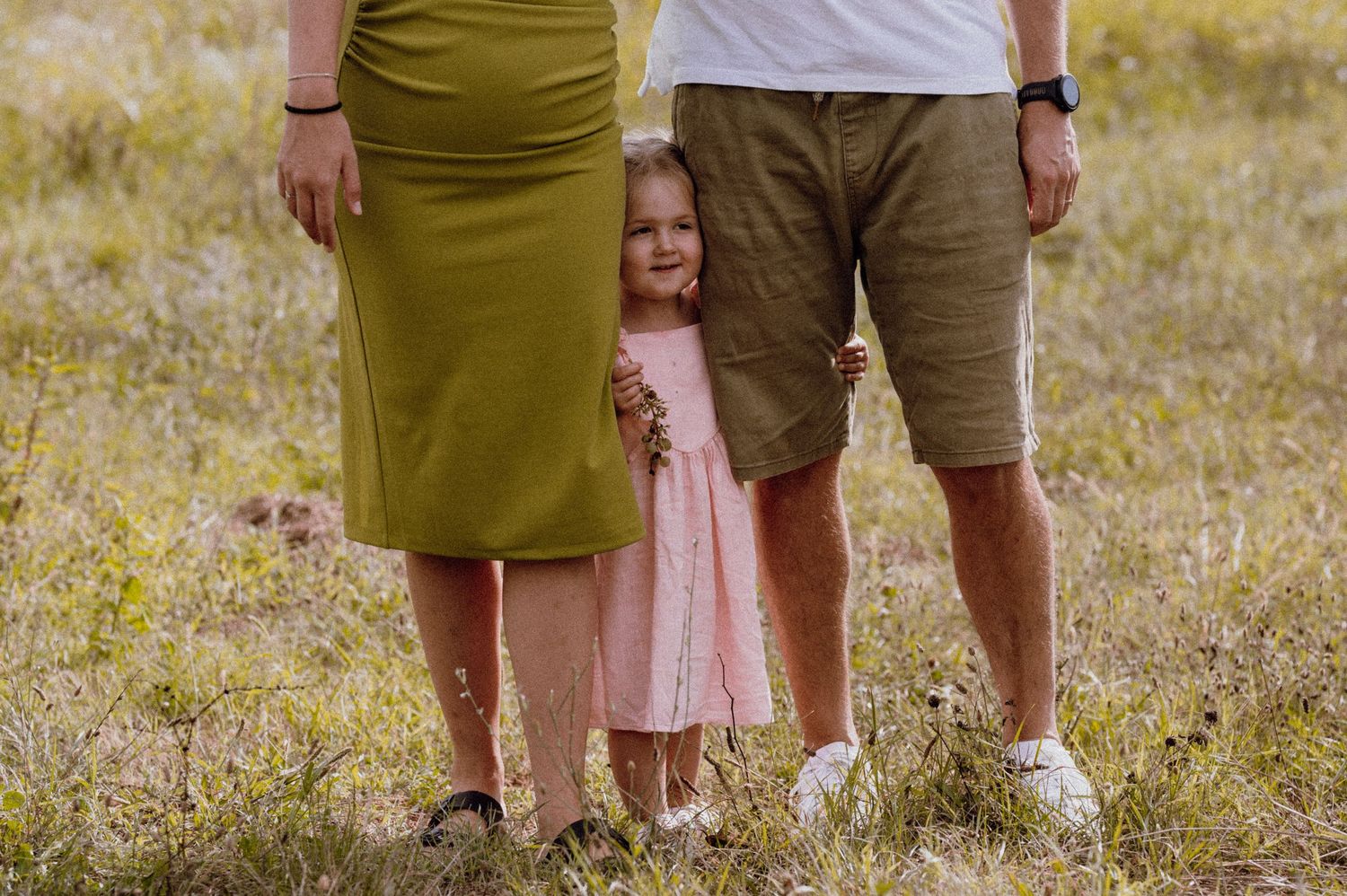 Happy family enjoying quality time with their little daughter in a sunny garden, Croatia