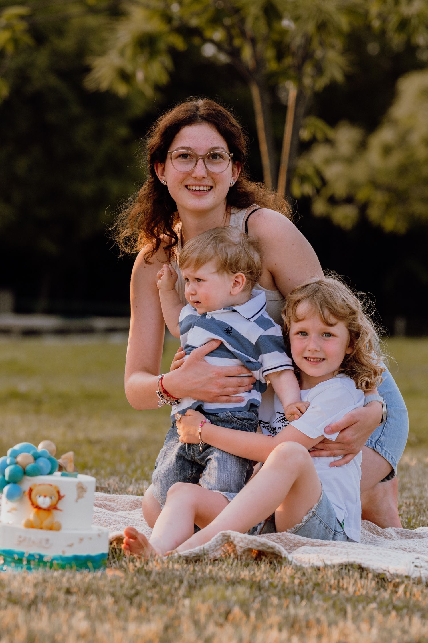 Sister celebrating with her younger brother and sister around a birthday cake – Croatia