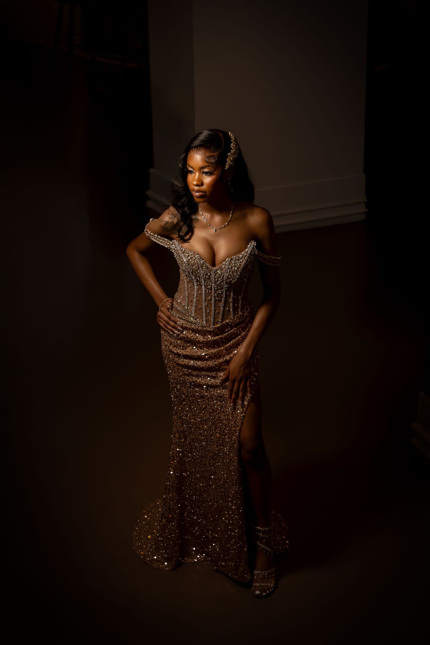 Glamorous sequined dress photoshoot in dramatic dark lighting with artistic poses.
