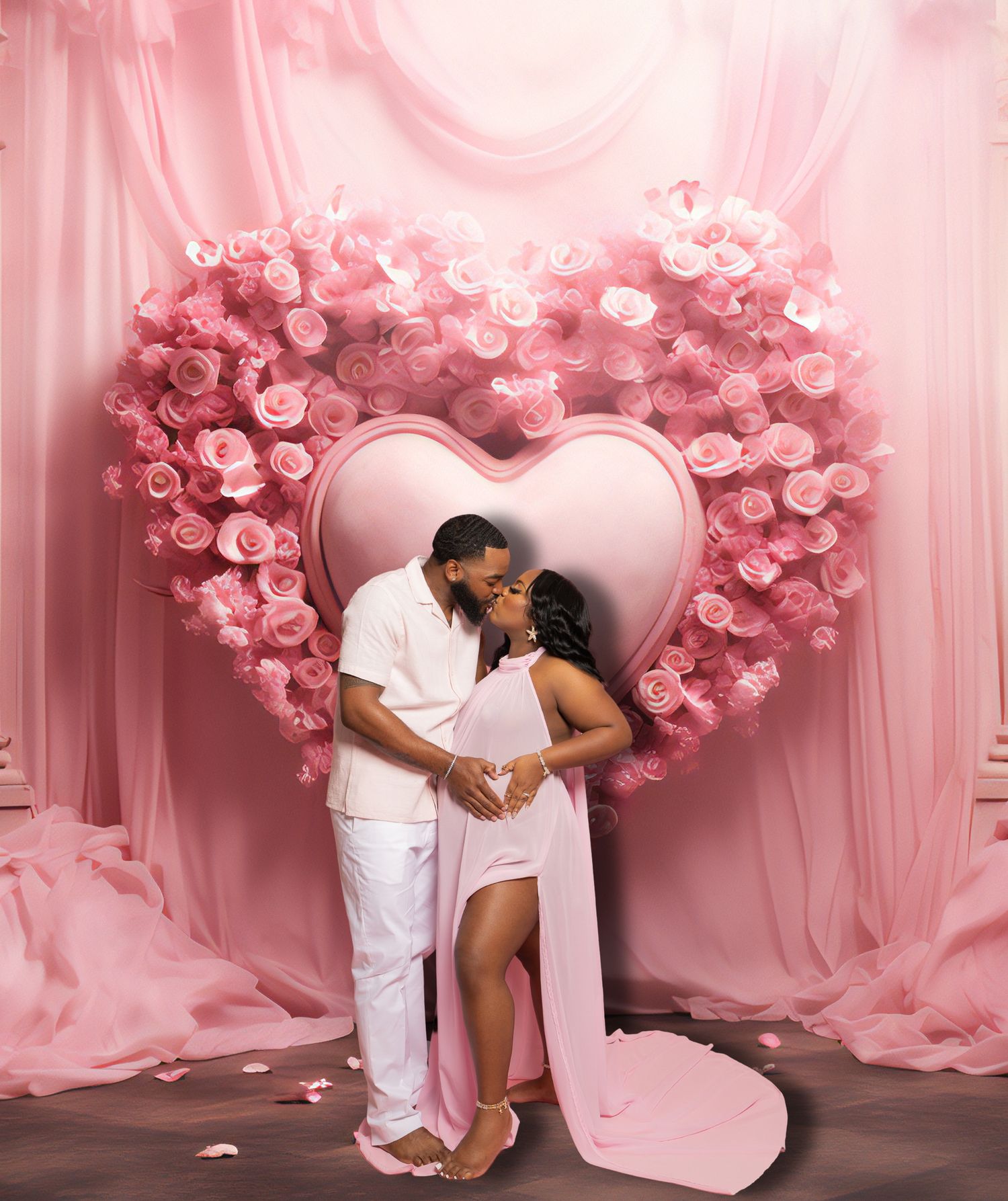 Romantic couple pose in heart-shaped floral arch with pink roses and flowing fabric backdrop.