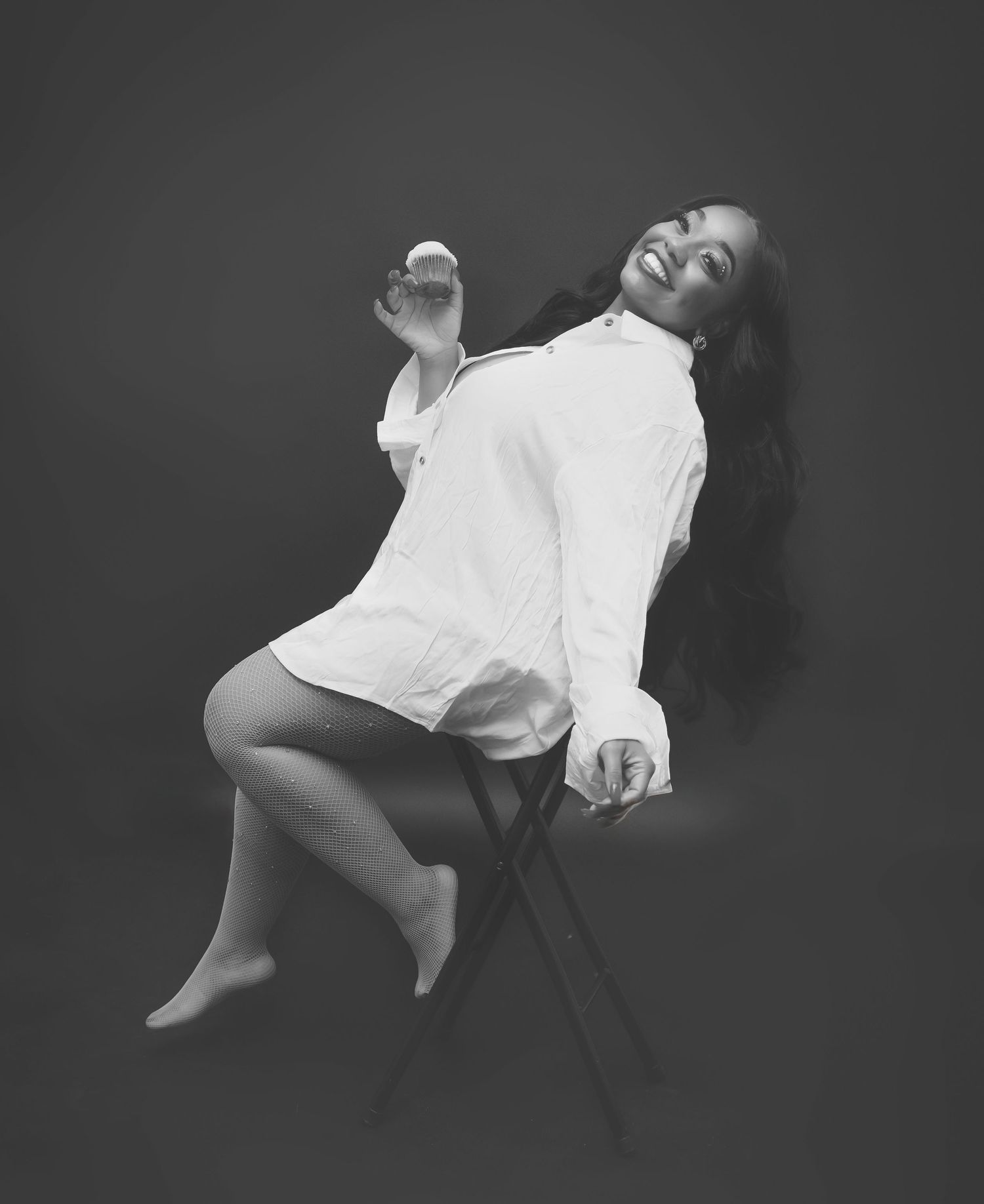 Black and white artistic portrait of figure in flowing white dress.