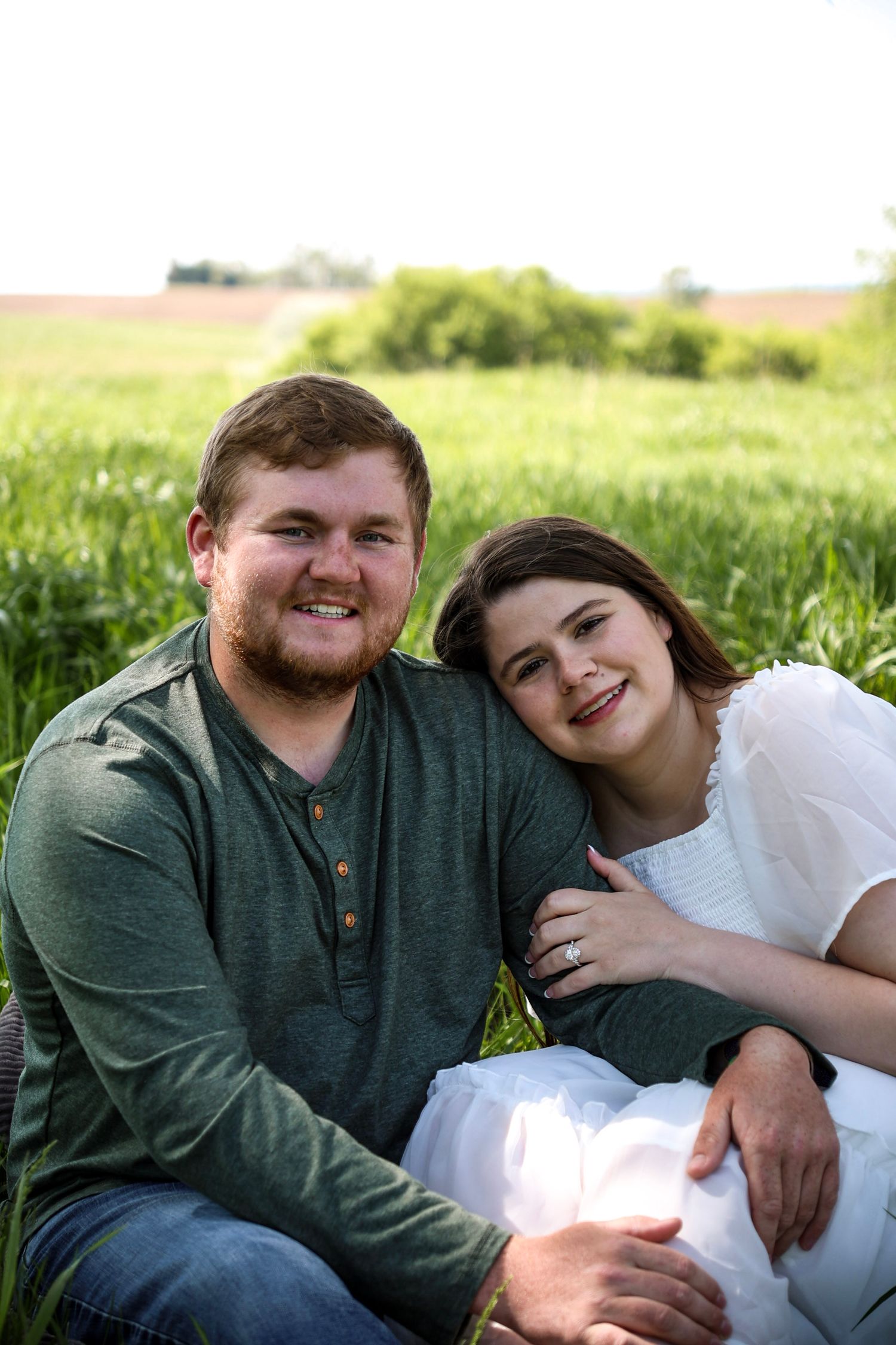 engagement pictures sitting in grass