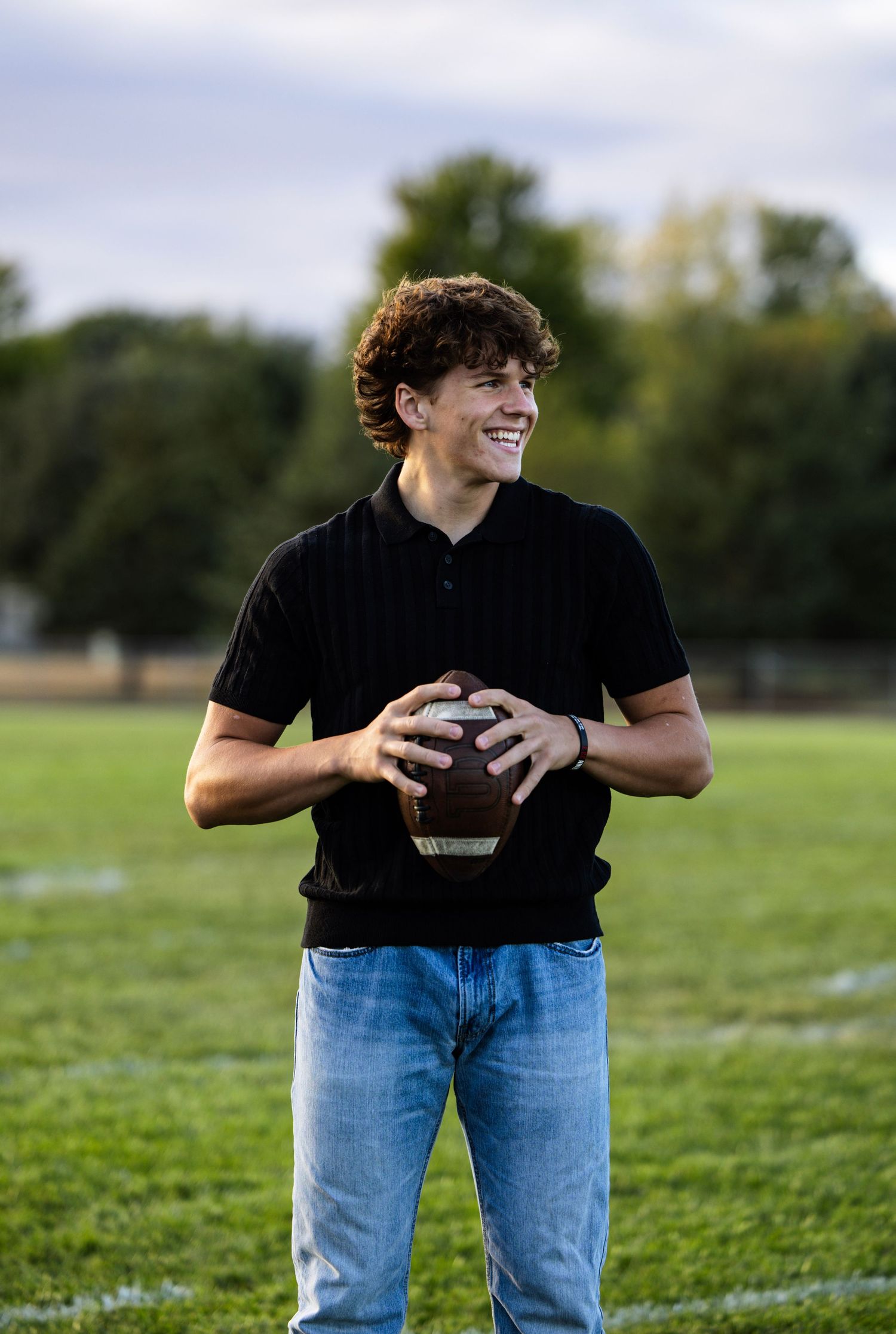 boy senior picture holding football