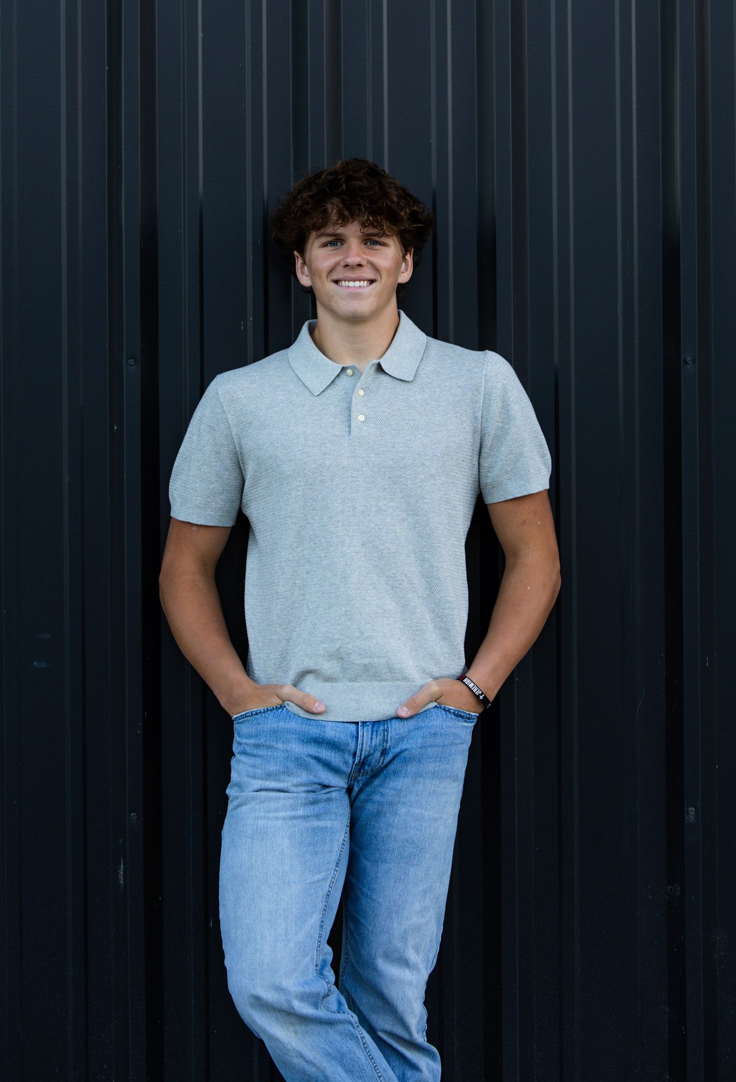 black background, boy senior picture, smiling
