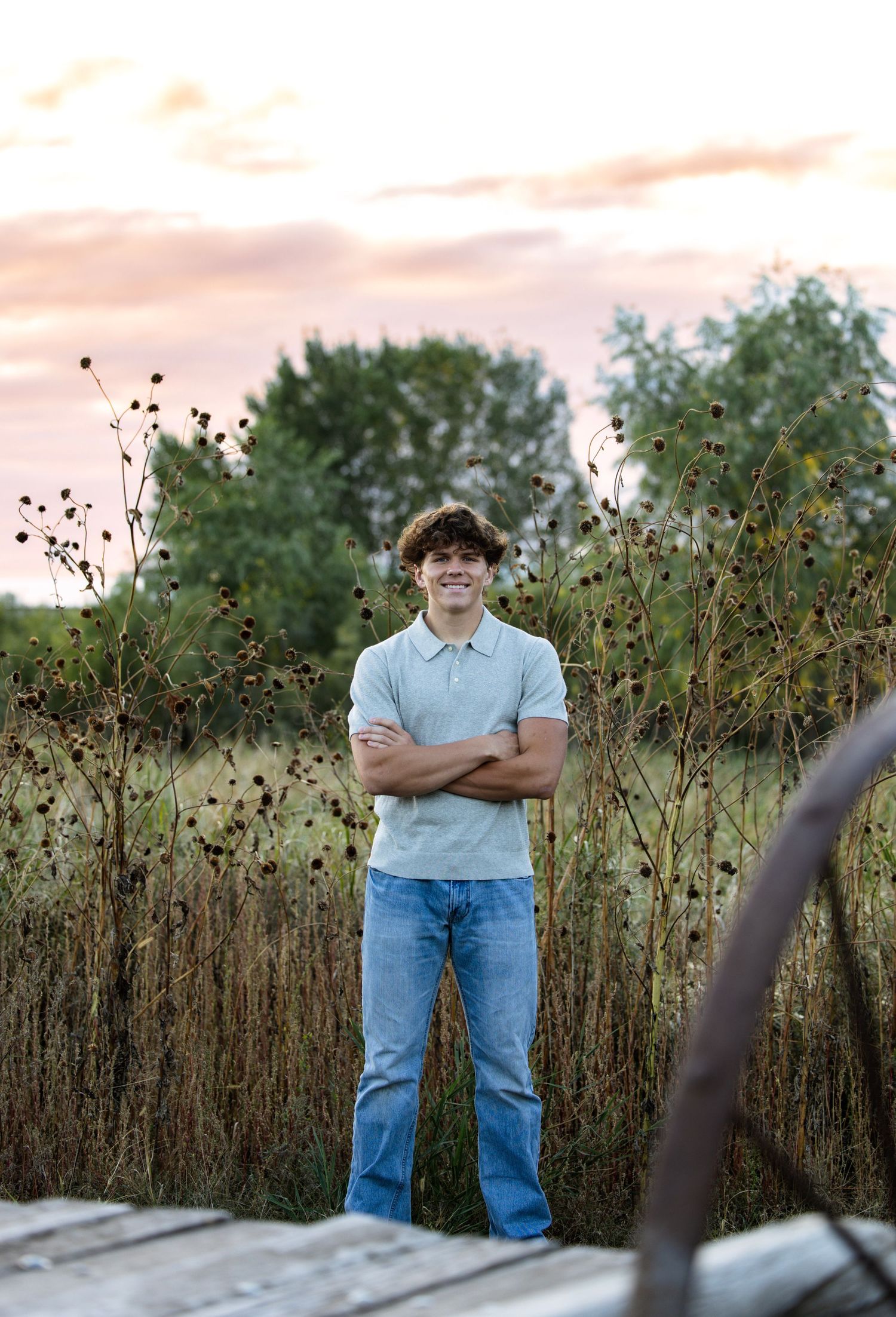 boy senior picture, outside, with sunset, arms crossed