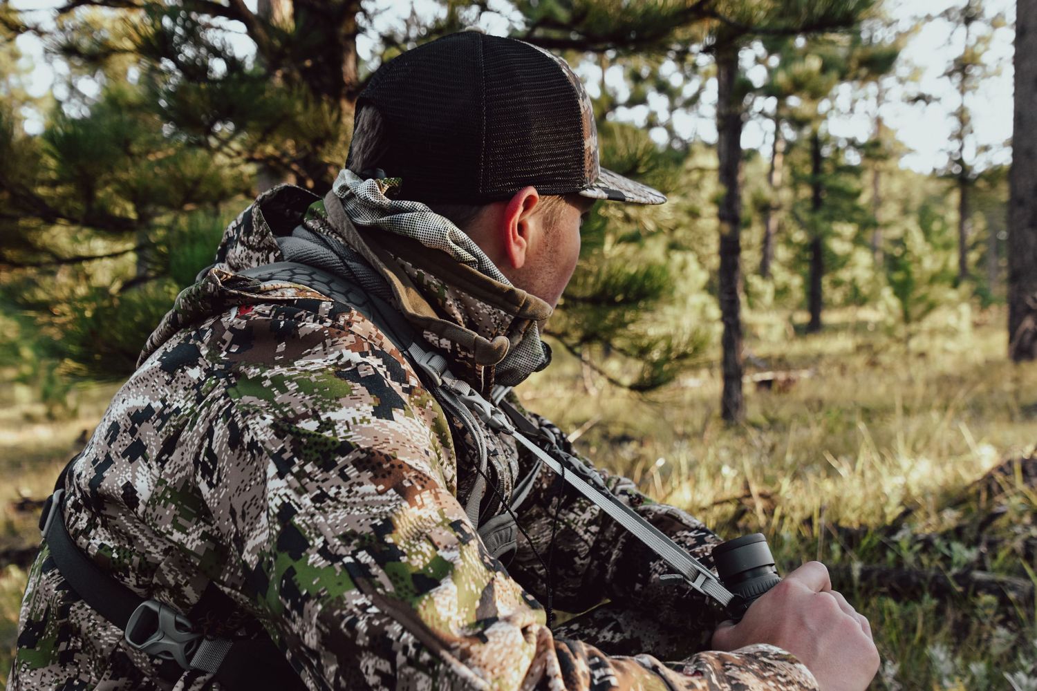 hunter sitting on the side of a mountain