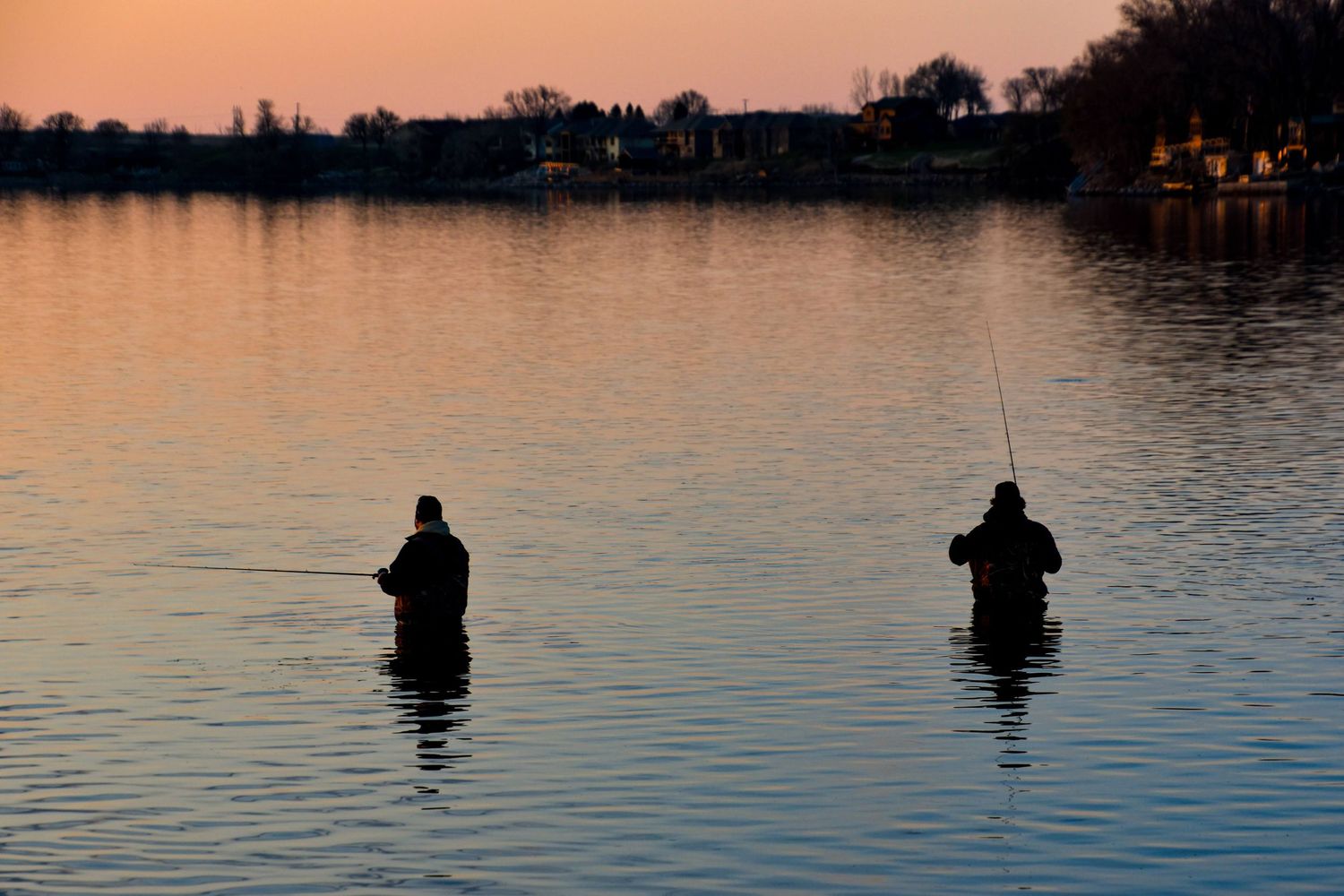 sillouette of two fishermen
