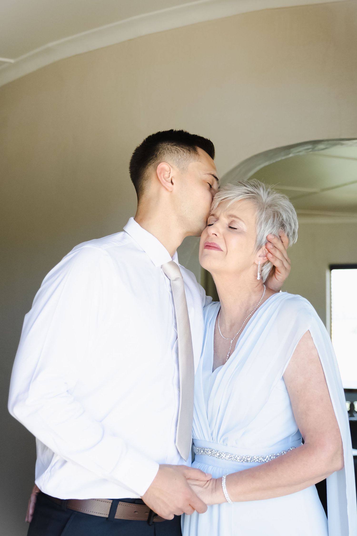 A romantic sequence showing an intimate embrace between two people in white clothing.