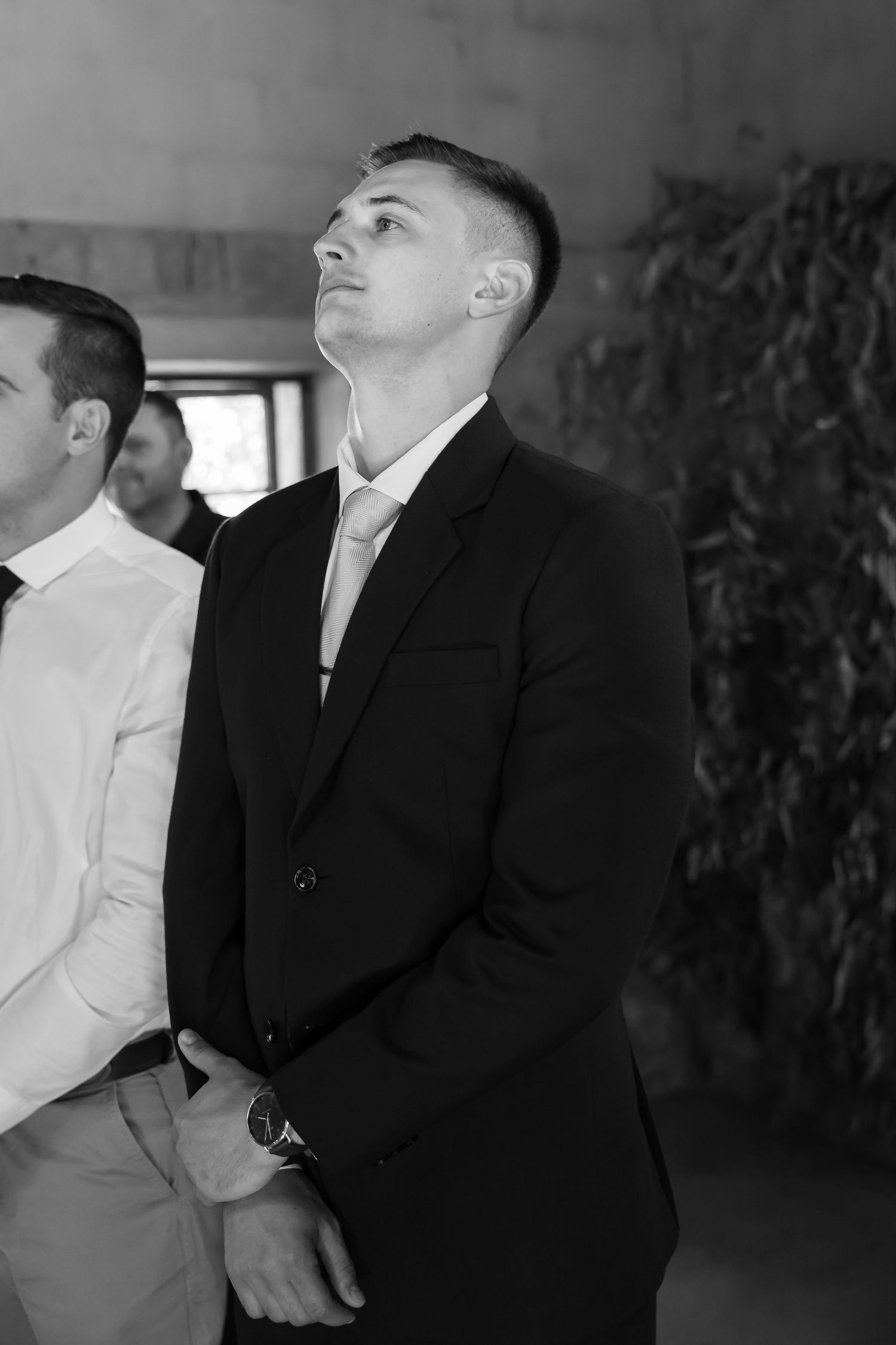 Series of black and white photos showing formal-dressed individuals in a dimly lit hallway.