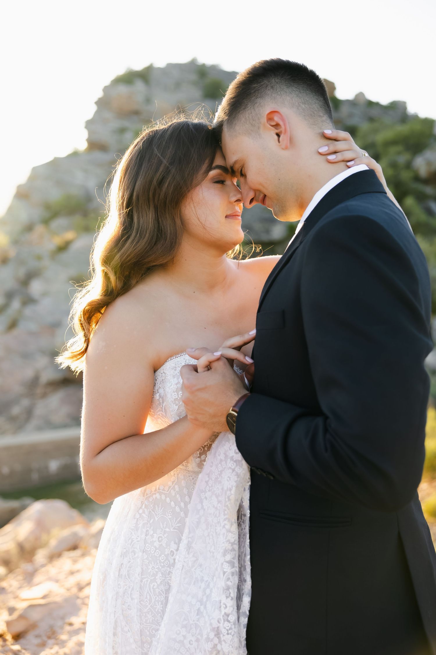 A romantic sequence of wedding photos showing a couple embracing at sunset against rocky cliffs.