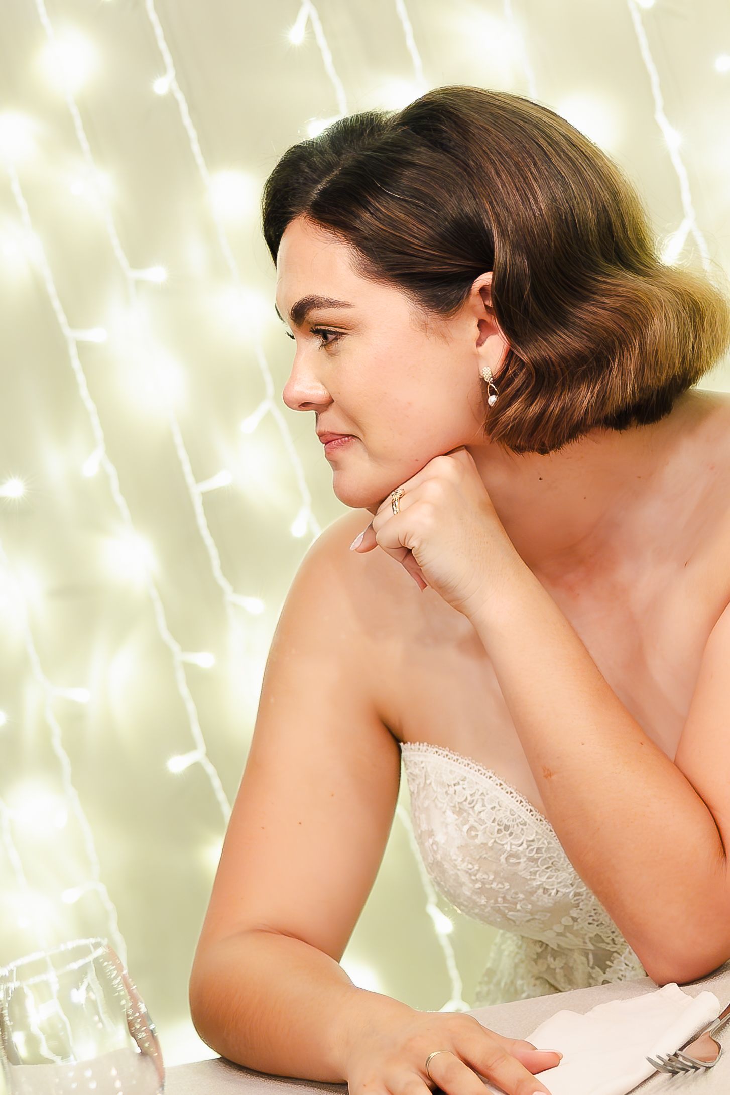 Artistic bridal portraits with twinkling fairy lights creating a magical bokeh background.