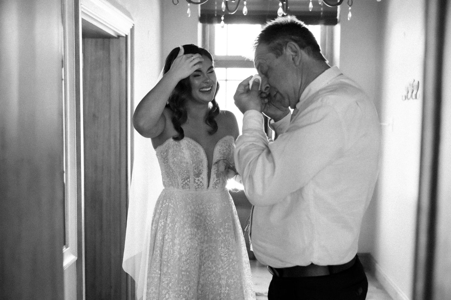 An intimate moment captured between newlyweds in an elegant indoor setting.