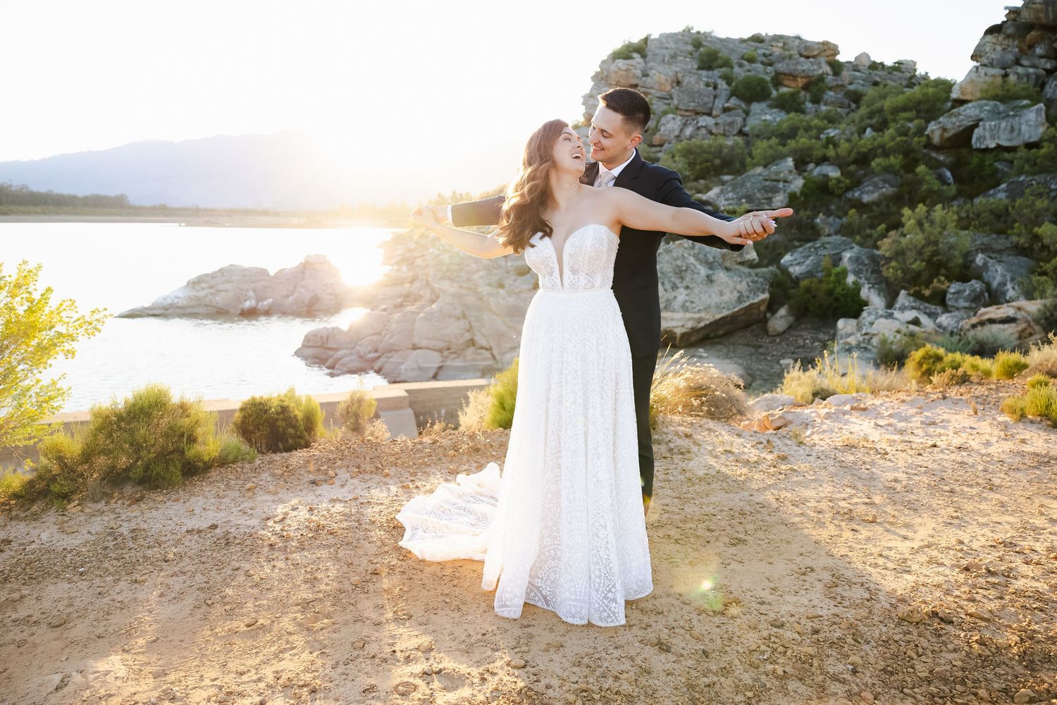 Romantic sunset photoshoot on rugged coastal cliffs with ocean views.
