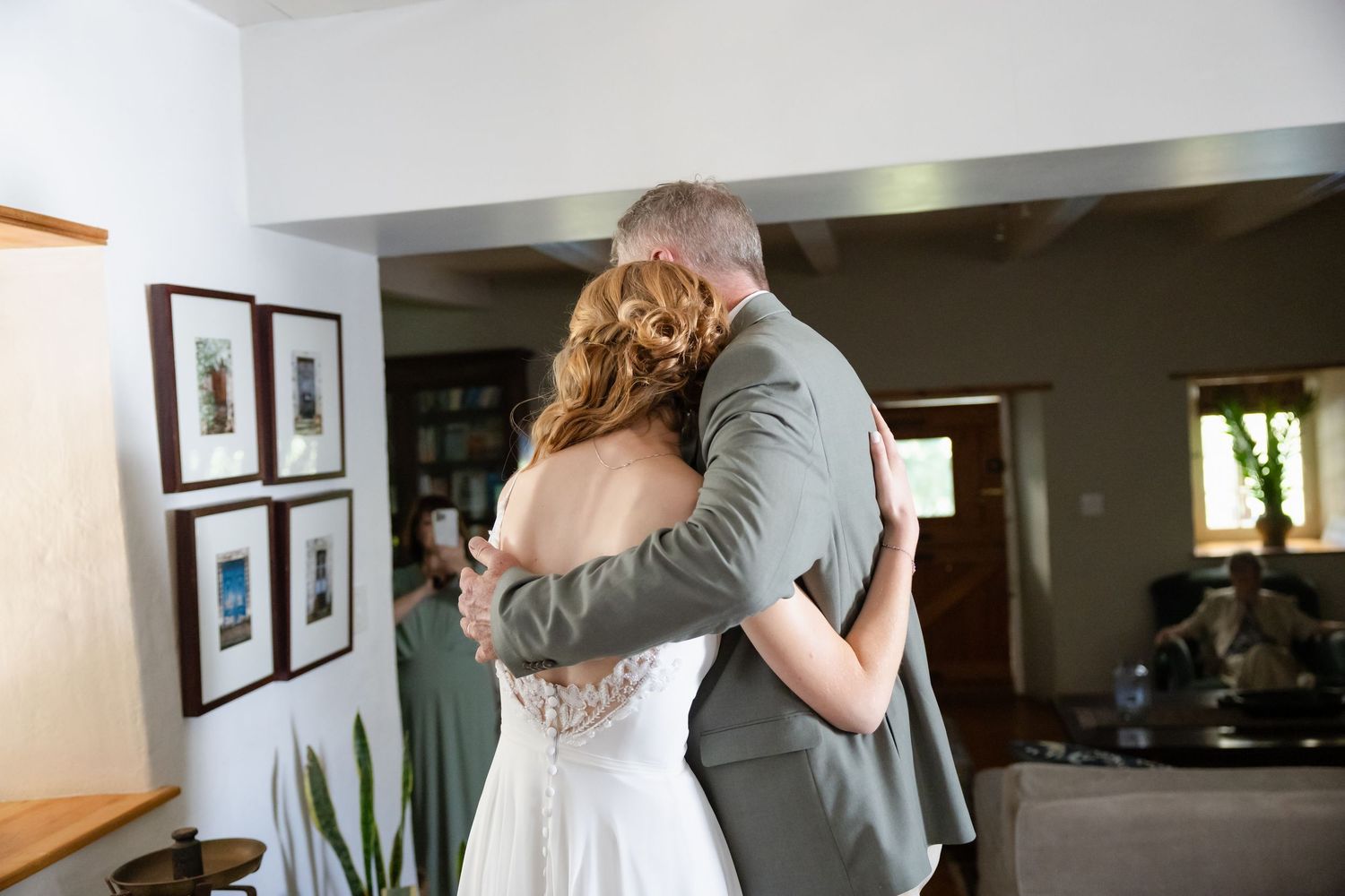 Father and bride share an intimate embrace during an emotional wedding day moment.