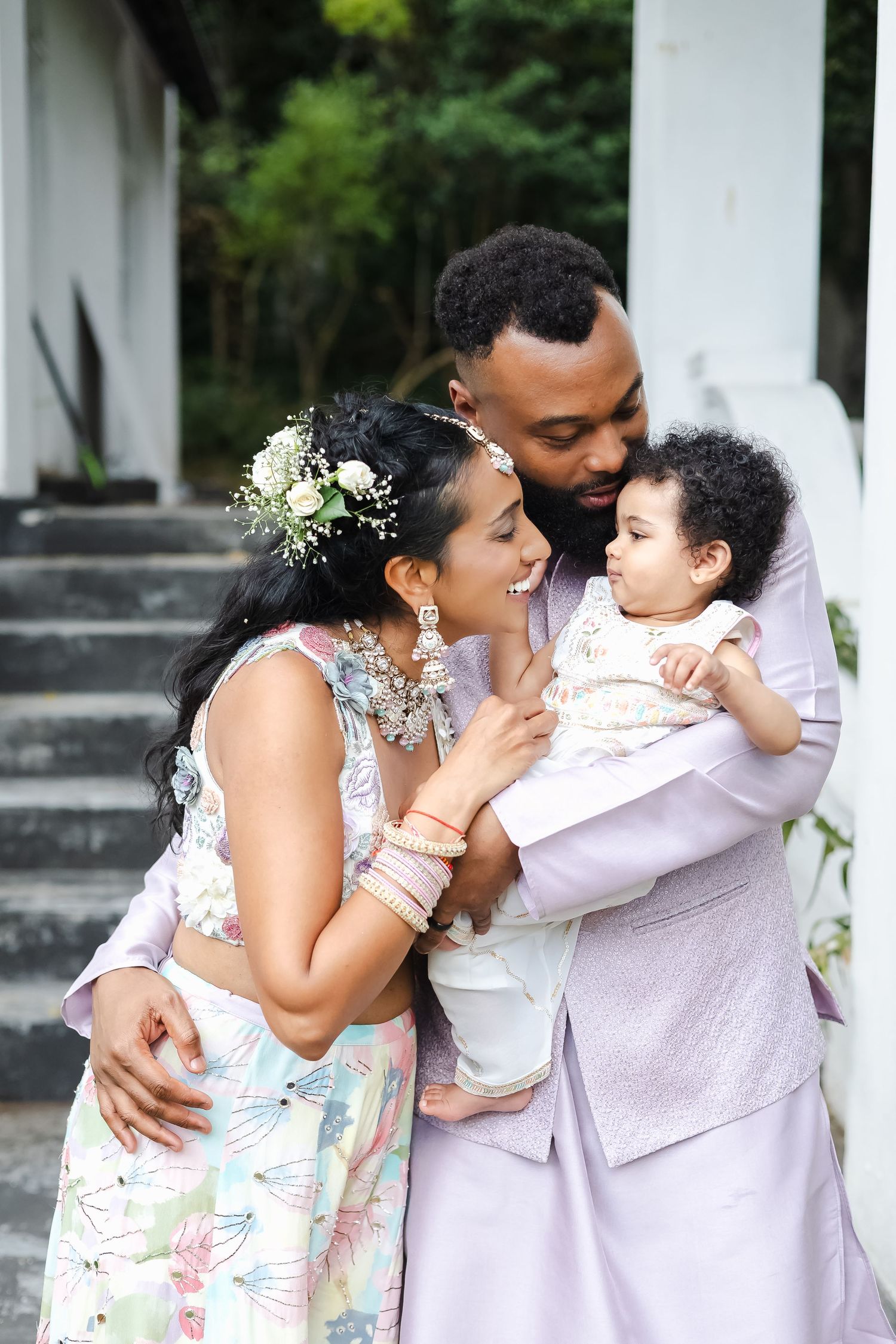 A series of candid family moments showing affectionate embraces and smiles in a garden setting.